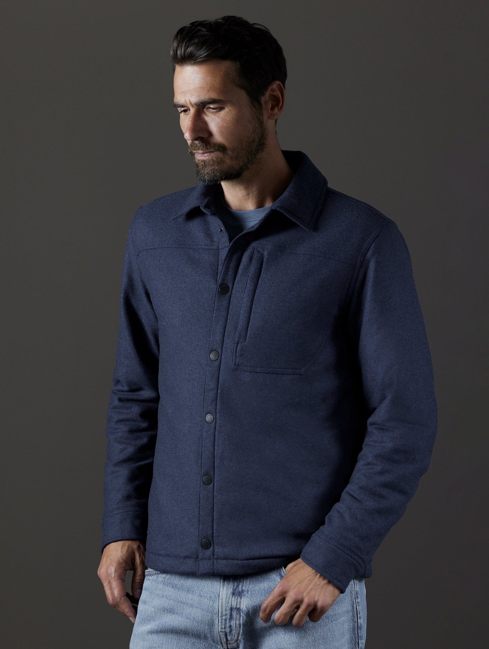 Front body view of man wearing Nova Insulated Button-Down in Total Eclipse Heather dark blue from AETHER Apparel.