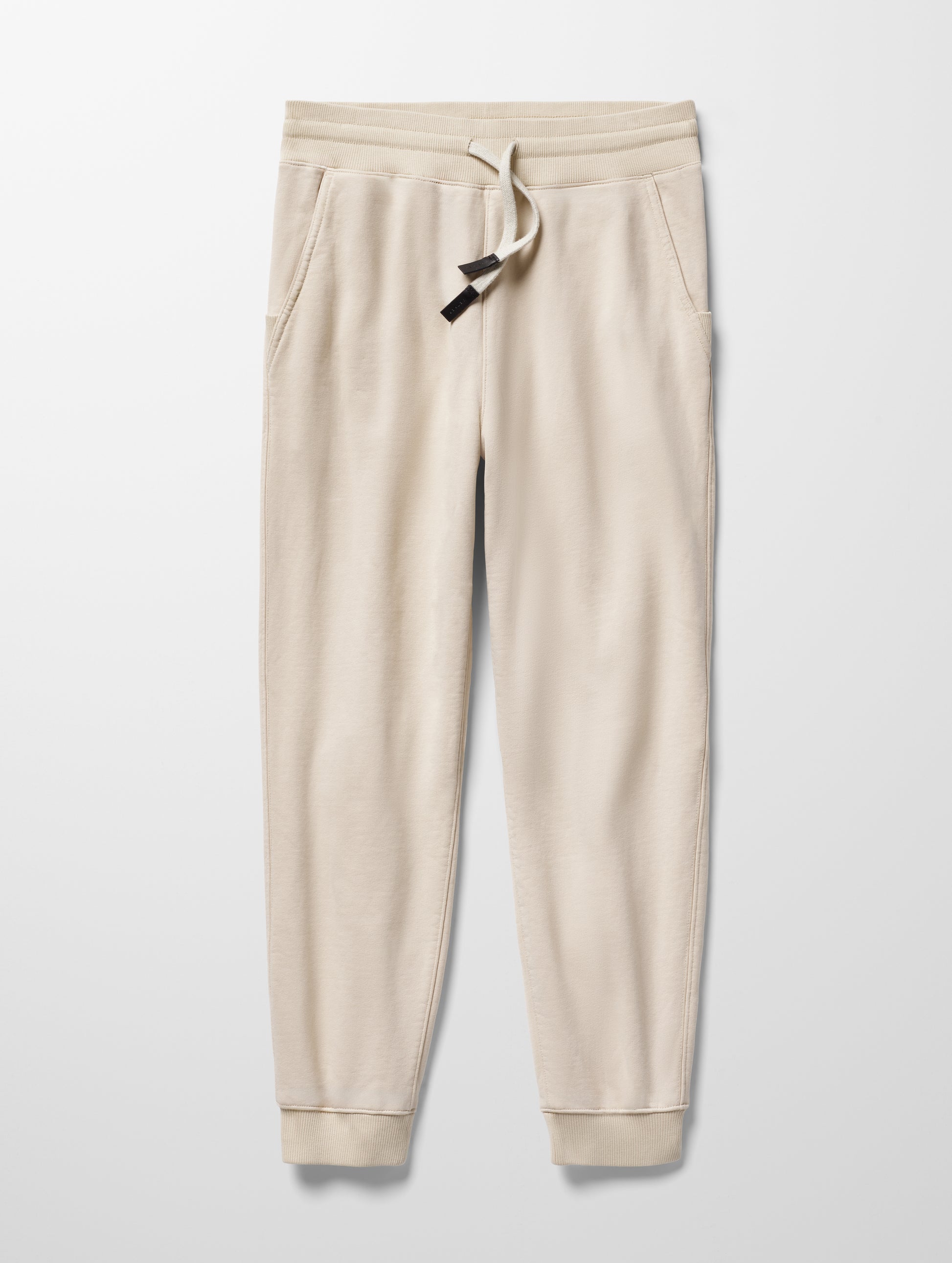 Flay lay image of Osa Cuffed Sweatpant in Bone white from AETHER Apparel.