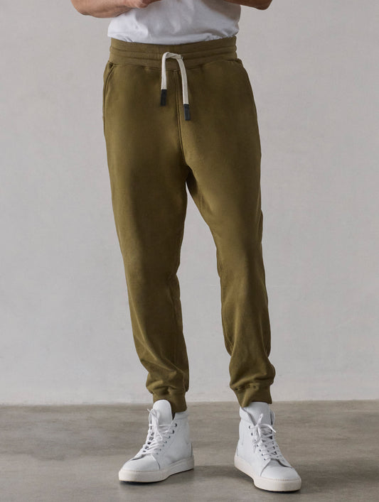 Front lower-body view of man wearing Osa Cuffed Sweatpant in Command Green from AETHER Apparel.