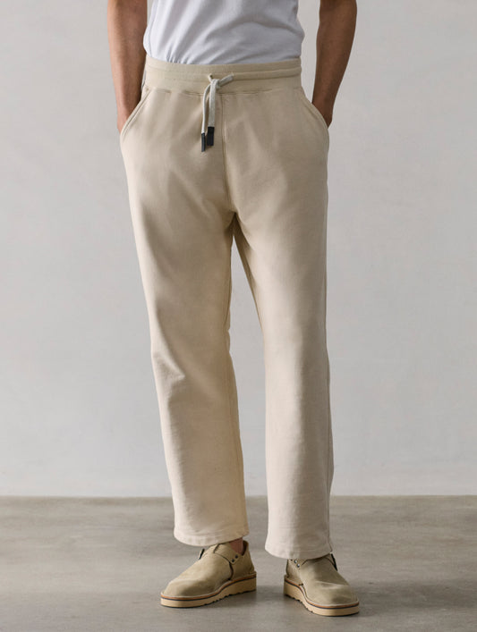Front lower body view of man wearing Osa Easy-Fit Sweatpant in Bone white from AETHER Apparel.