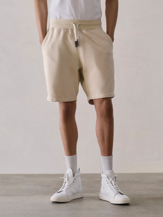Front lower body view of man wearing Osa Sweatshort in Bone white from AETHER Apparel.