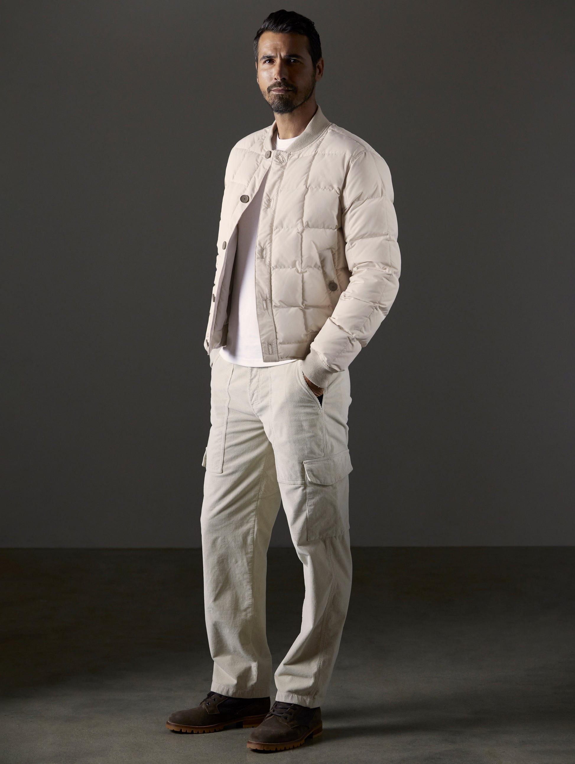 Front full body view of man wearing Pacer Jacket in Bone white from AETHER Apparel.