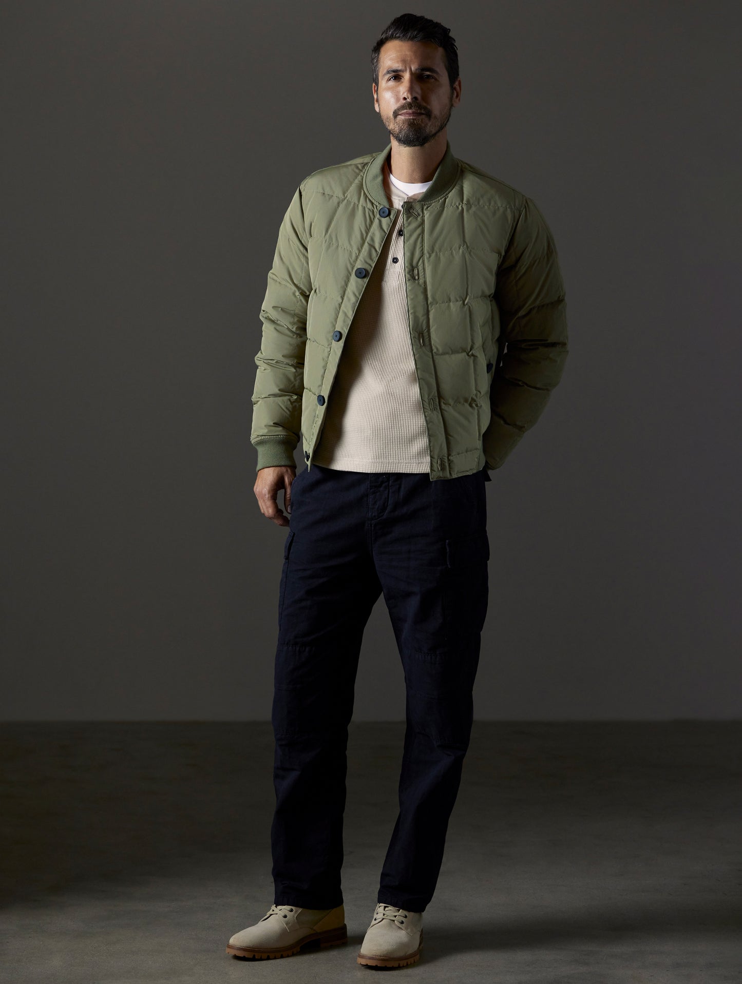 Front full-body view of man wearing Pacer Jacket in Fern Green from AETHER Apparel.