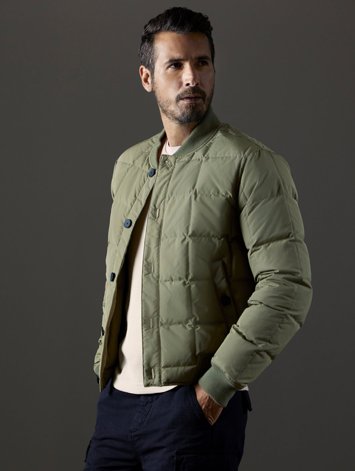 Front 3/4 body view of man wearing Pacer Jacket in Fern Green from AETHER Apparel.