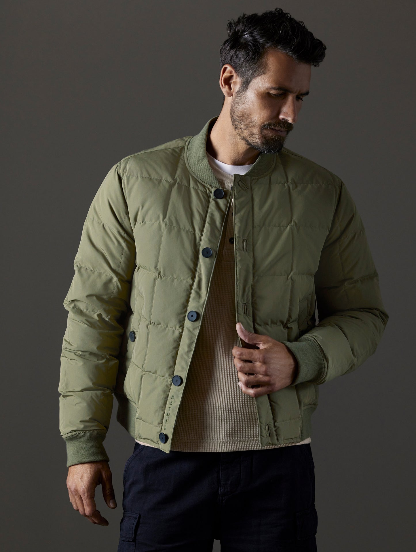 Front body view of man wearing Pacer Jacket in Fern Green from AETHER Apparel.