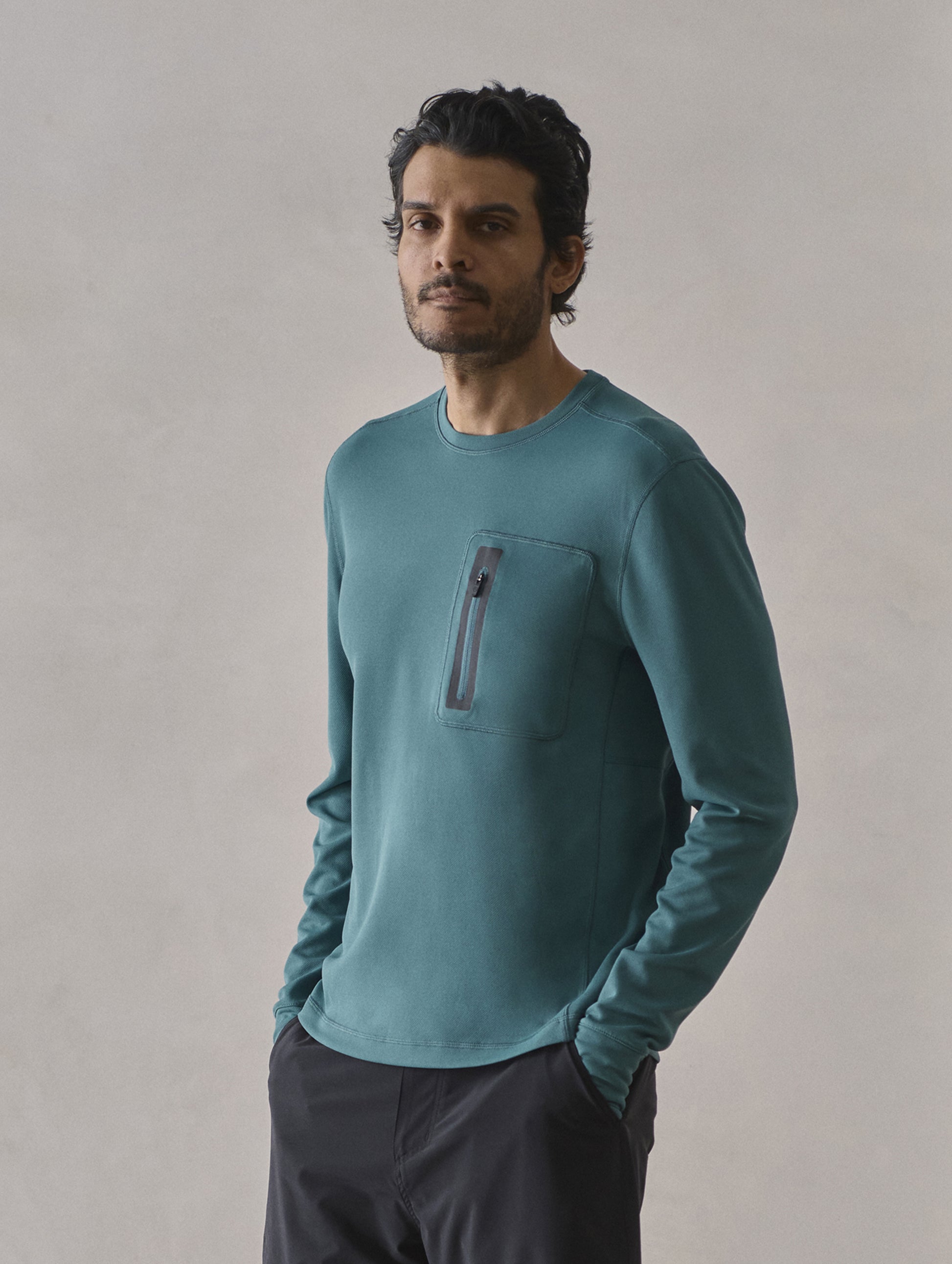 Front 3/4 upper-body view of man wearing Pacific Crewneck Sun Shirt in Aqua Blue from AETHER Apparel.