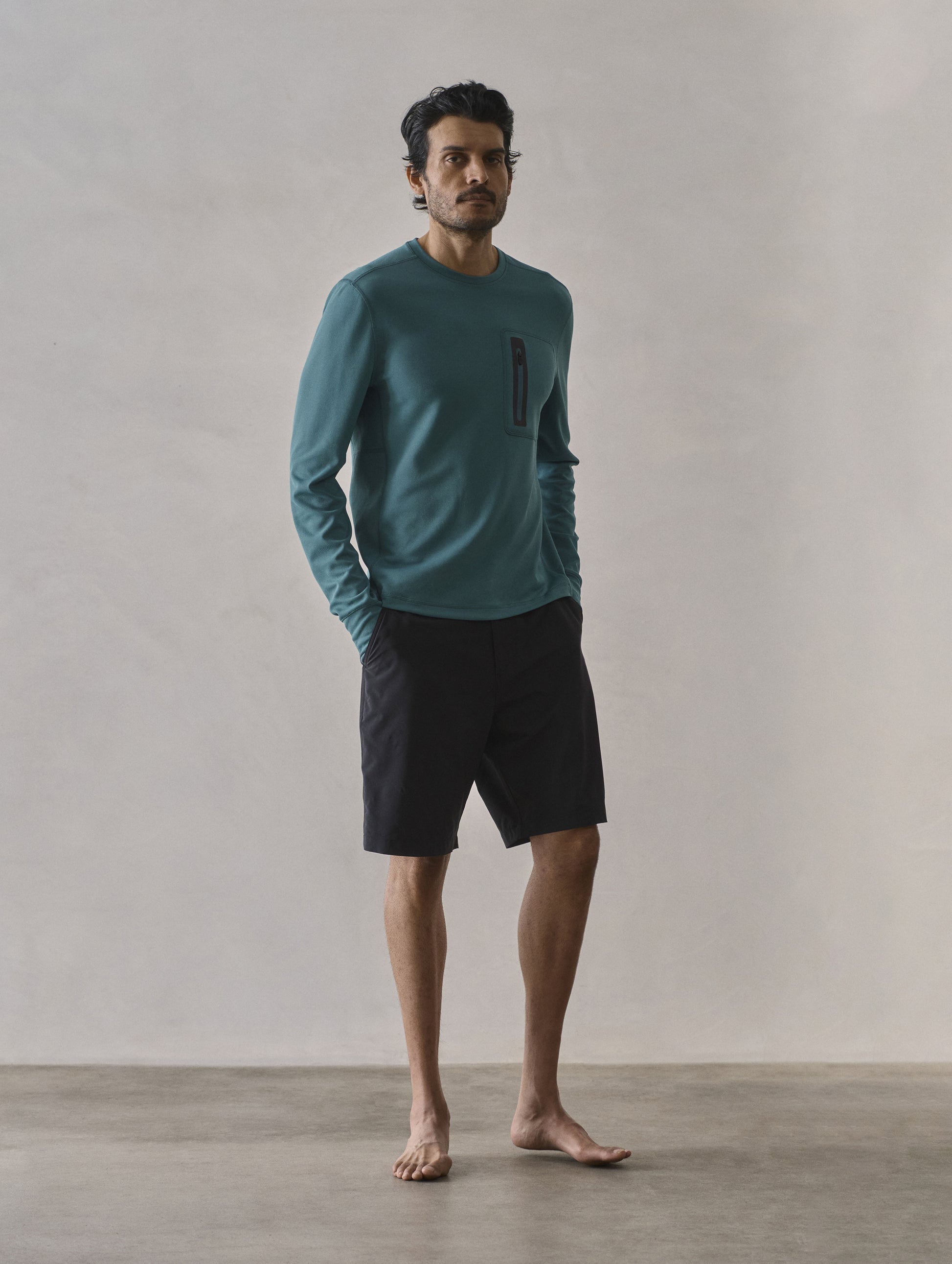 Front 3/4 full-body view of man wearing Pacific Crewneck Sun Shirt in Aqua Blue from AETHER Apparel.