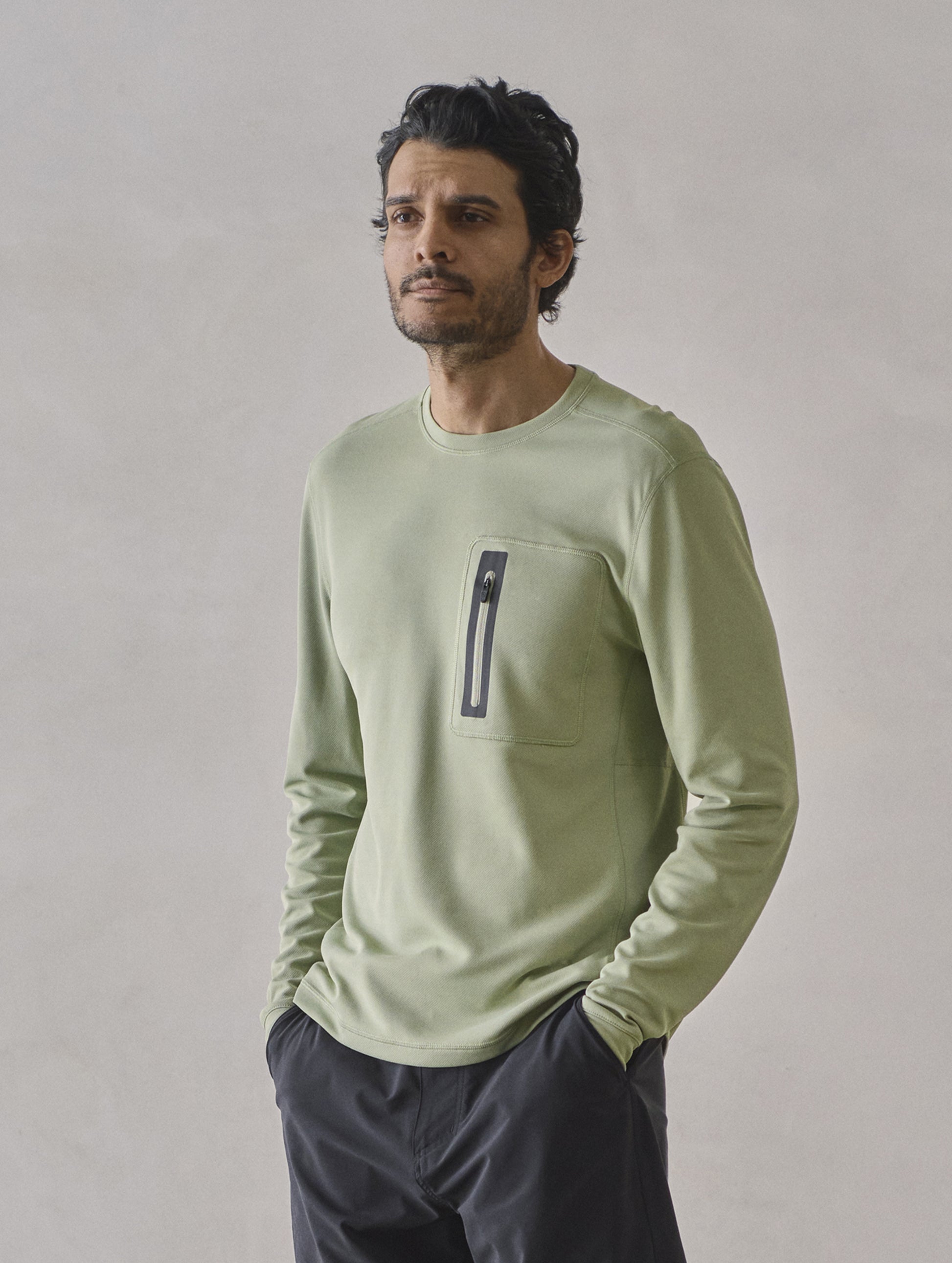Front 3/4 upper-body view of man wearing Pacific Crewneck Sun Shirt in Sage Green from AETHER Apparel.