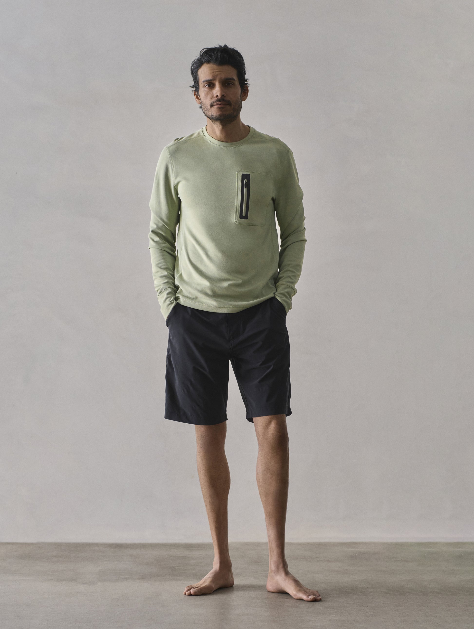 Front full-body view of man wearing Pacific Crewneck Sun Shirt in Sage Green from AETHER Apparel.