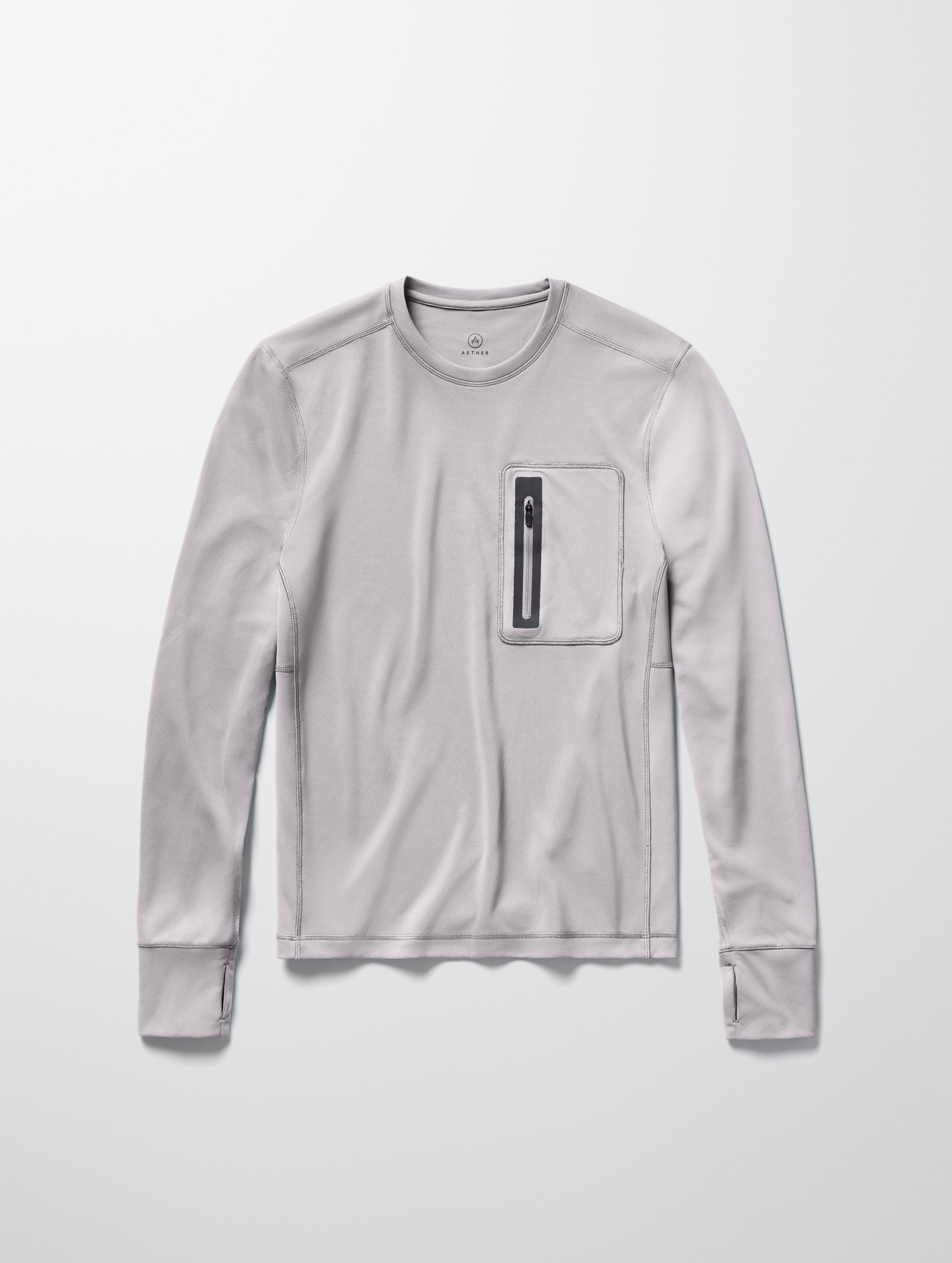 Flay lay image of men’s Pacific Crewneck Sun Shirt in Sky Grey from AETHER Apparel.