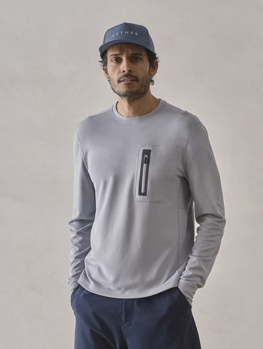Front upper-body view of man wearing Pacific Crewneck Sun Shirt in Sky Grey from AETHER Apparel.