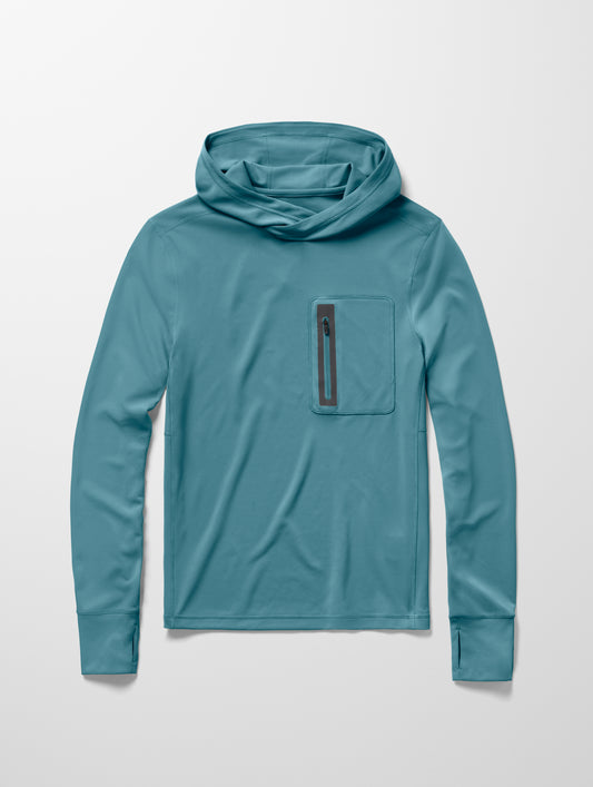 Flay lay image of men’s Pacific Hooded Sun Shirt in Aqua Blue from AETHER Apparel.