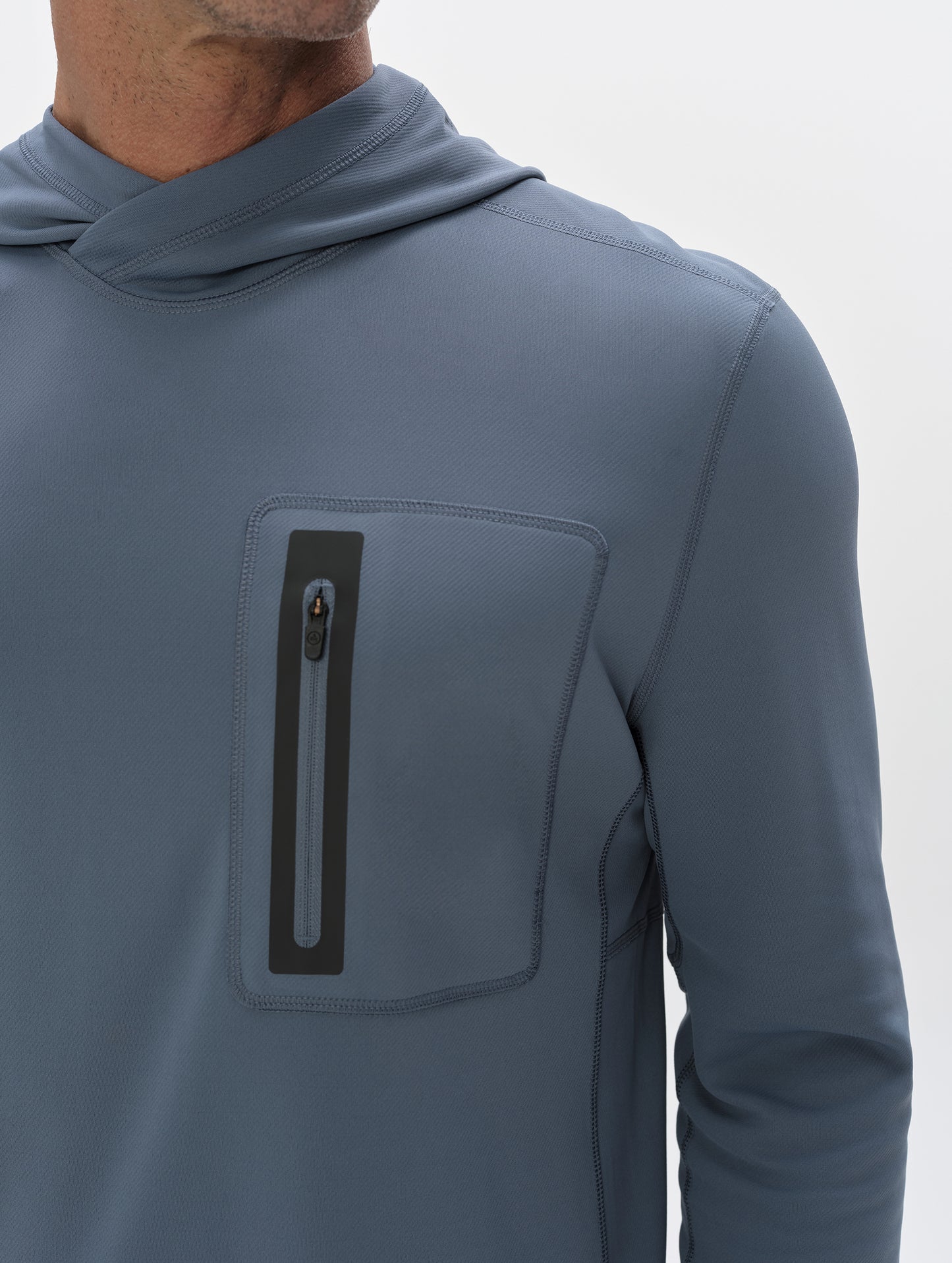 Closeup front upper-body view of man wearing Pacific Hooded Sun Shirt in Portal Blue from AETHER Apparel.