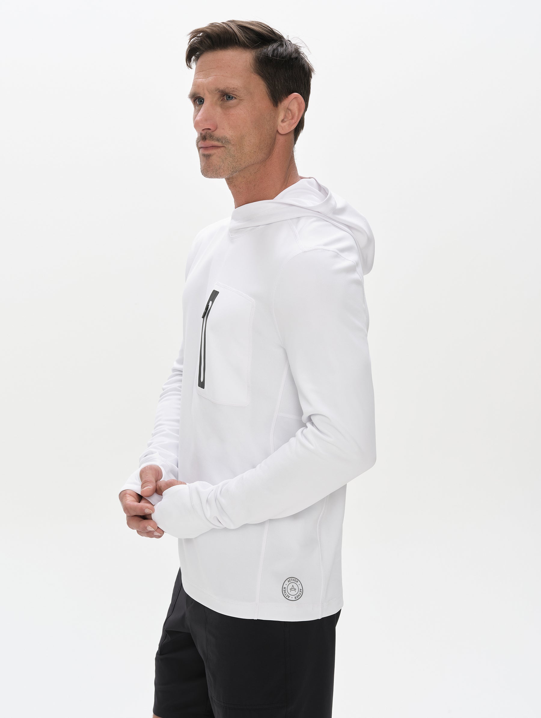 Front 3/4 upper-body view of man wearing Pacific Hooded Sun Shirt in White from AETHER Apparel.