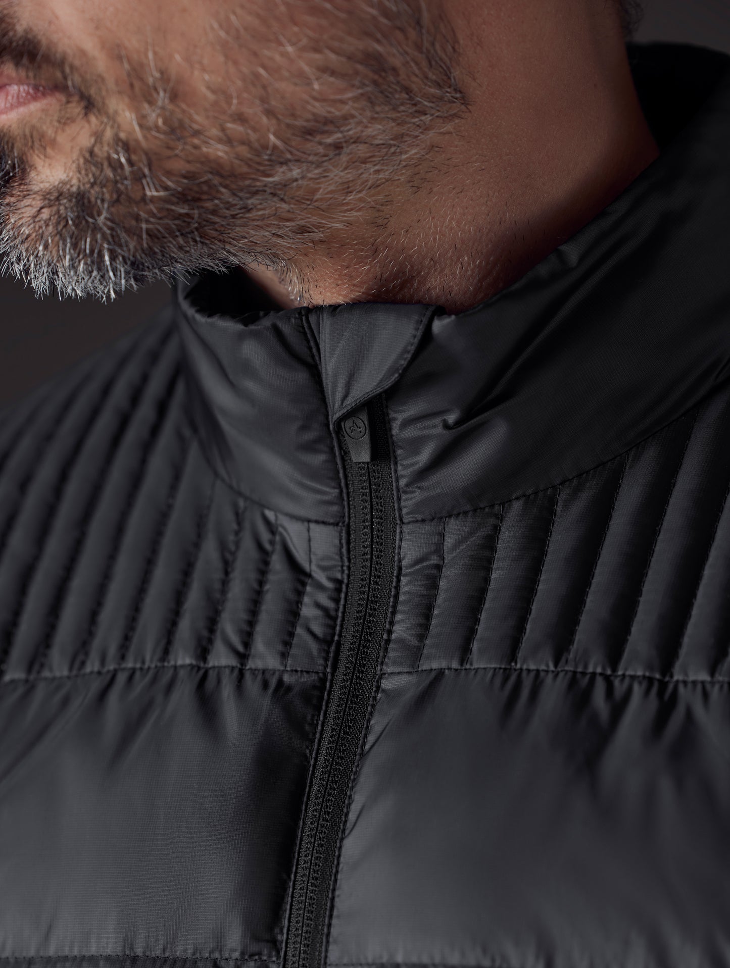 man wearing a black insulated jacket from AETHER Apparel