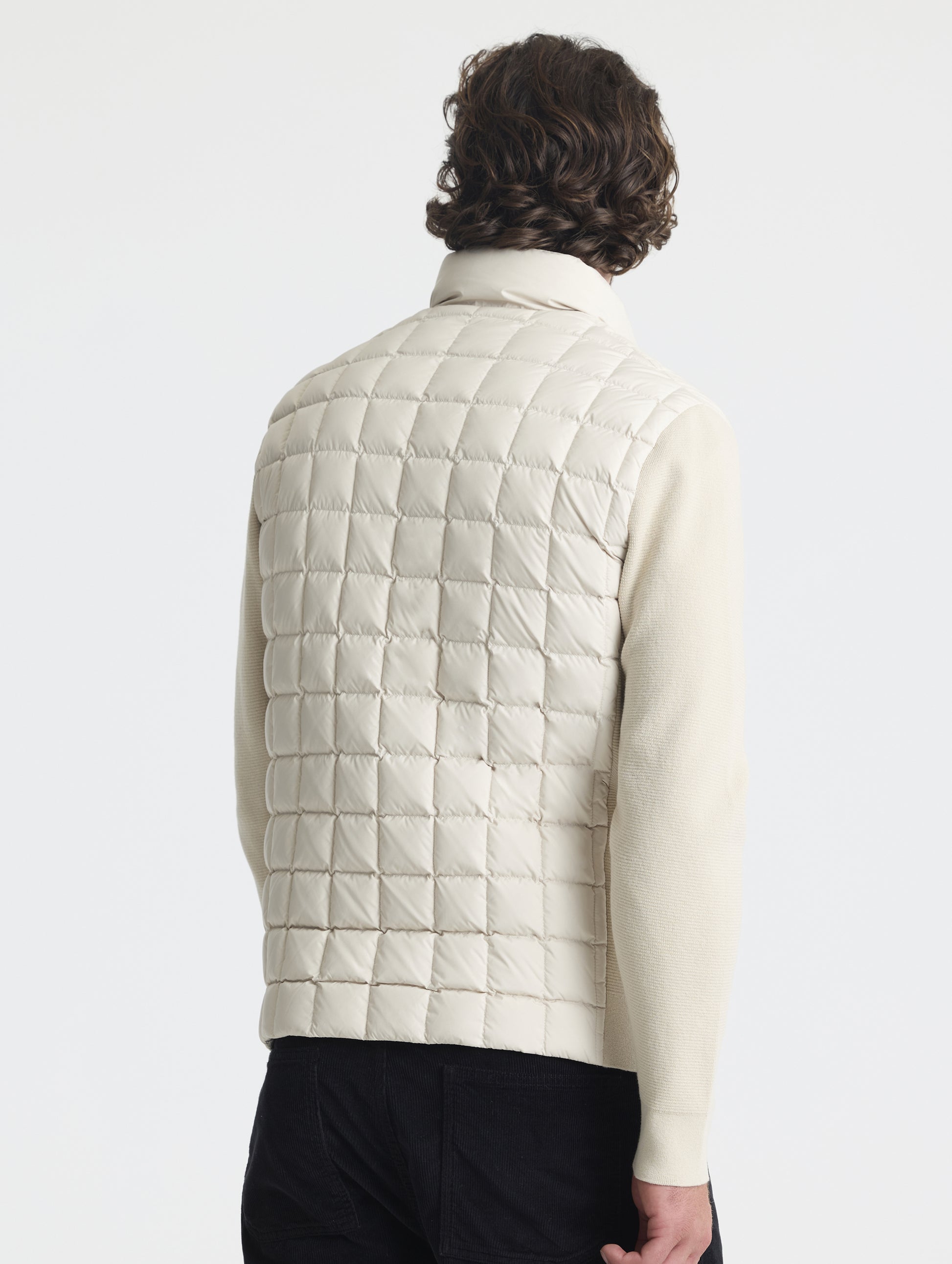 Rear, angled upper-body view of man wearing M Phase Full-Zip in Bone white from AETHER Apparel.