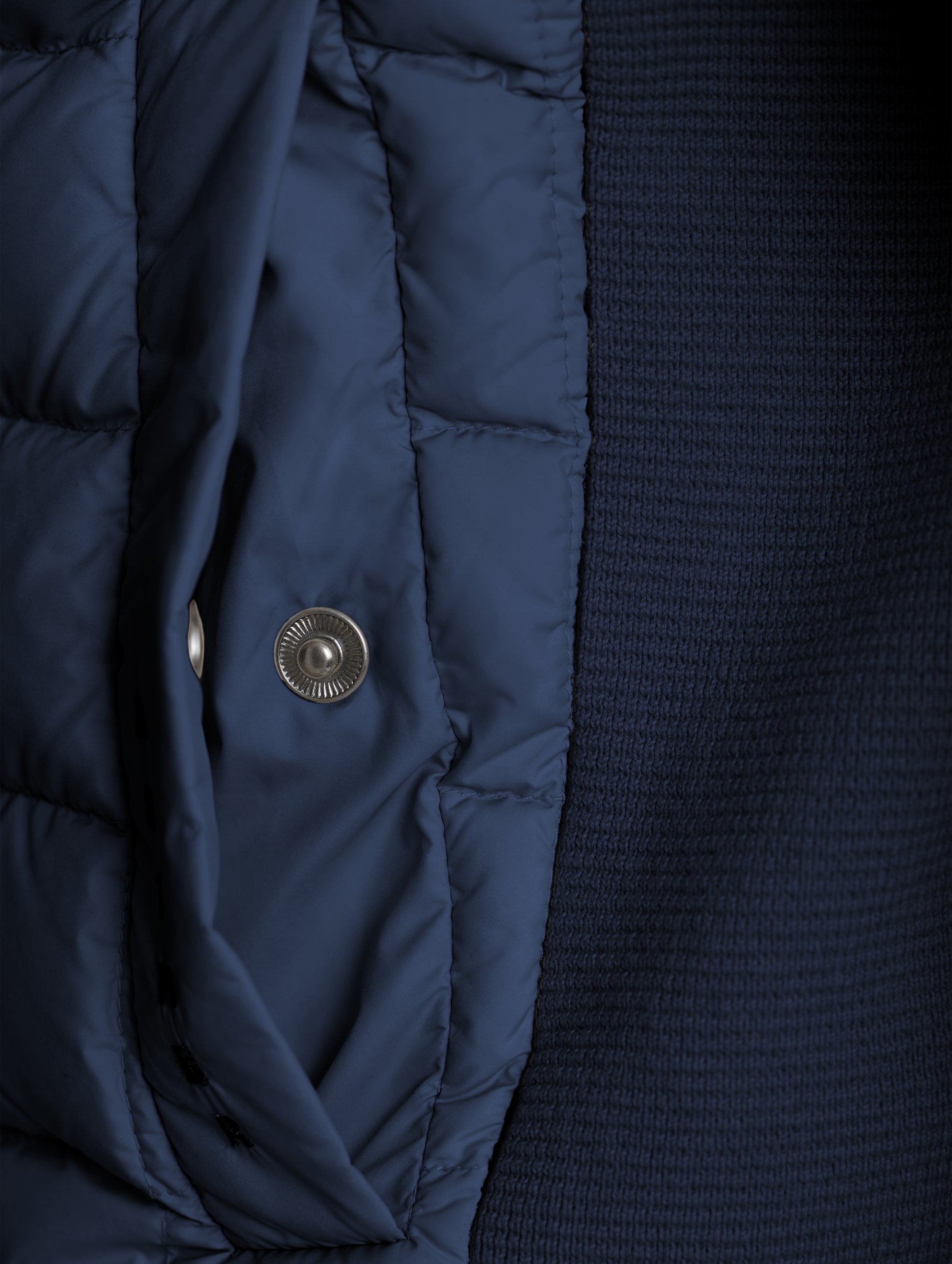 Closeup detailed view of the snap-secured welt hand pocket on the M Phase Full-Zip in Total Eclipse dark blue from AETHER Apparel.
