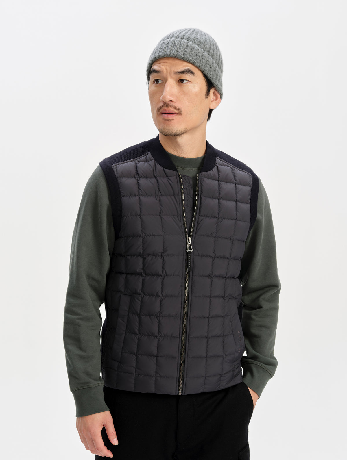 Front upper-body view of man wearing the M Phase Vest in Onyx Black from AETHER Apparel. 