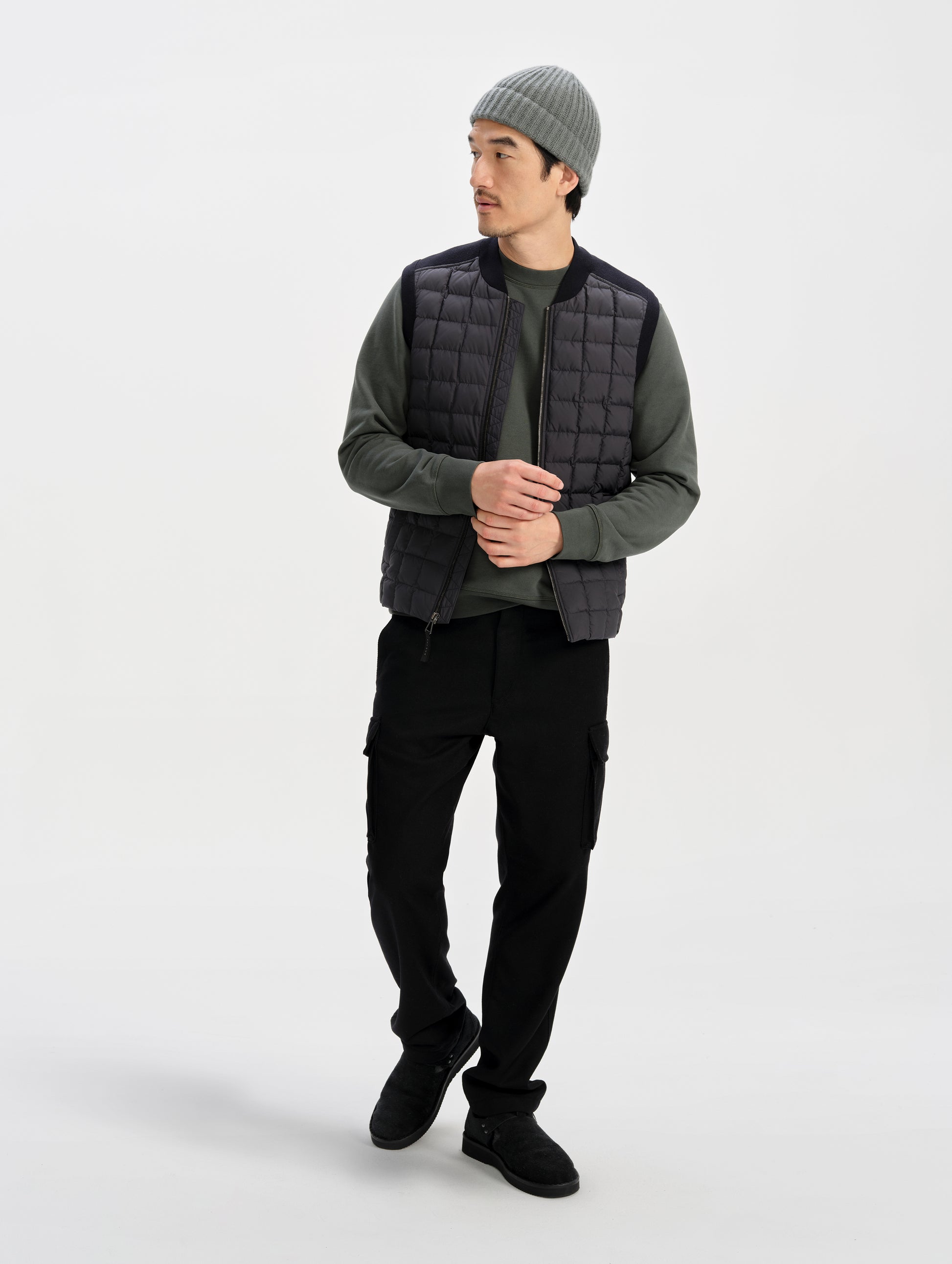 Front full-body view of man wearing the M Phase Vest in Onyx Black from AETHER Apparel. 
