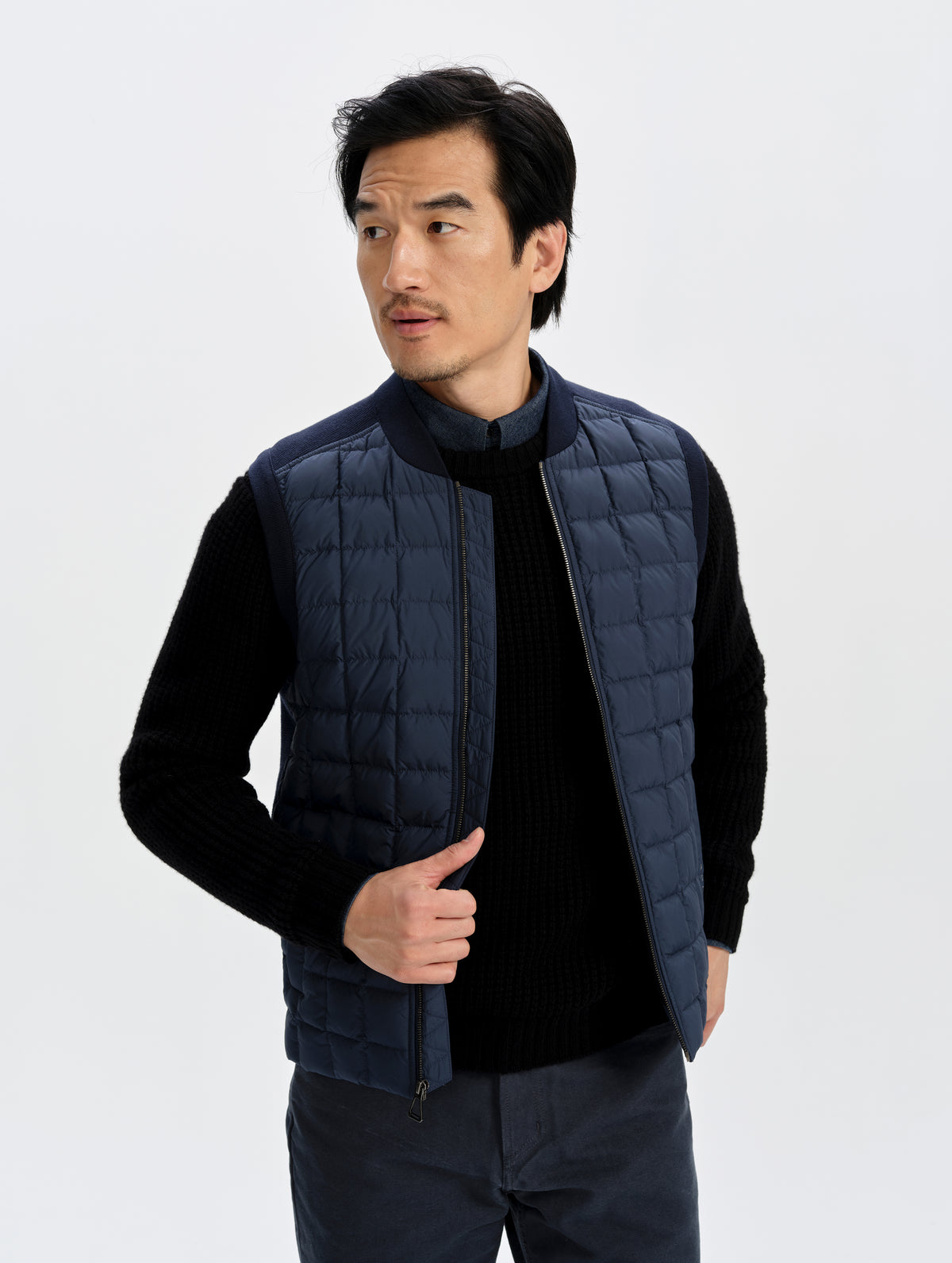 Front upper-body view of man wearing the M Phase Vest in Total Eclipse from AETHER Apparel. 