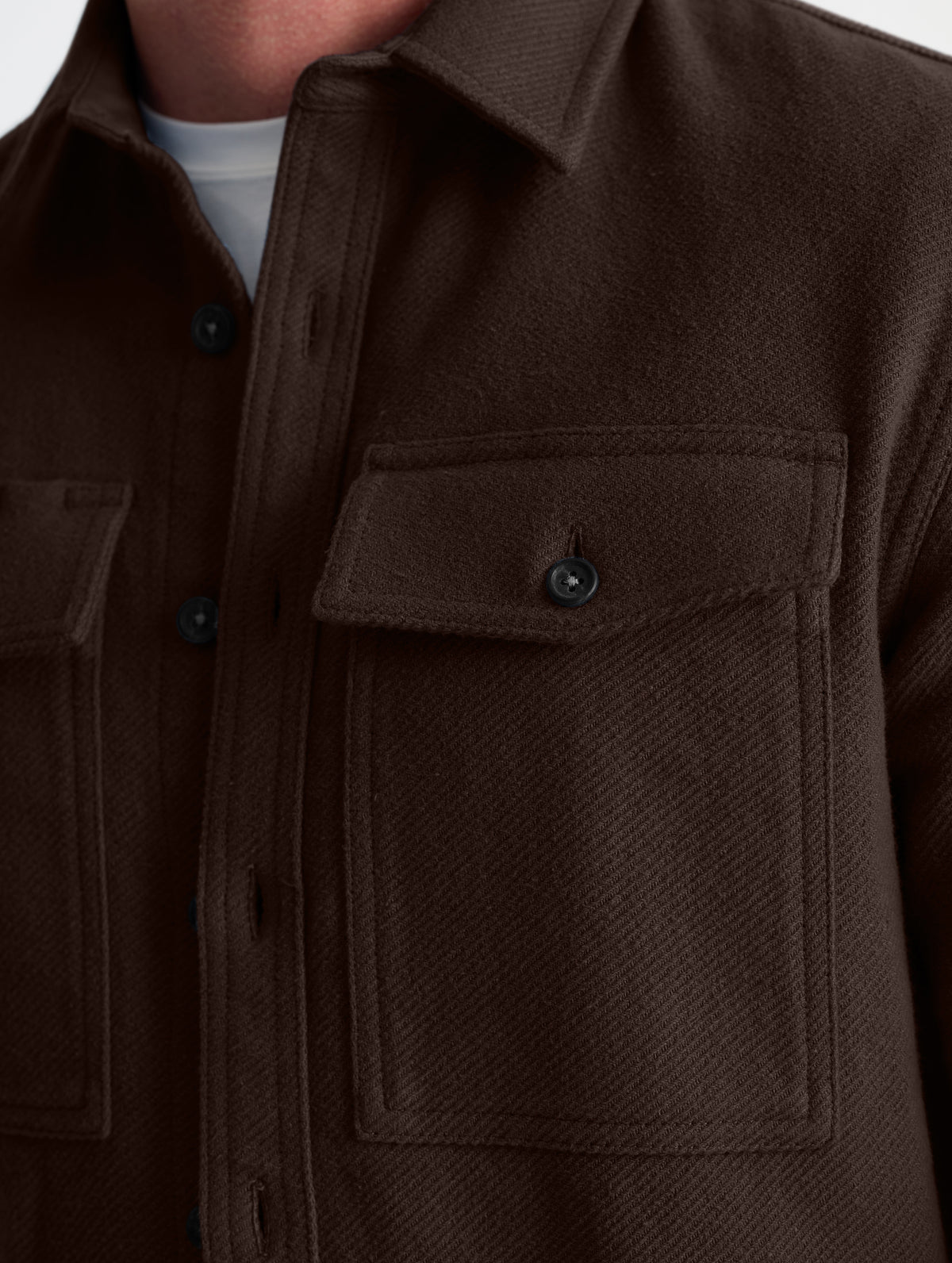 Closeup detailed view of the button-secured chest pockets on the Pioneer Heavyweight Button-Down in Ash Brown from AETHER Apparel.