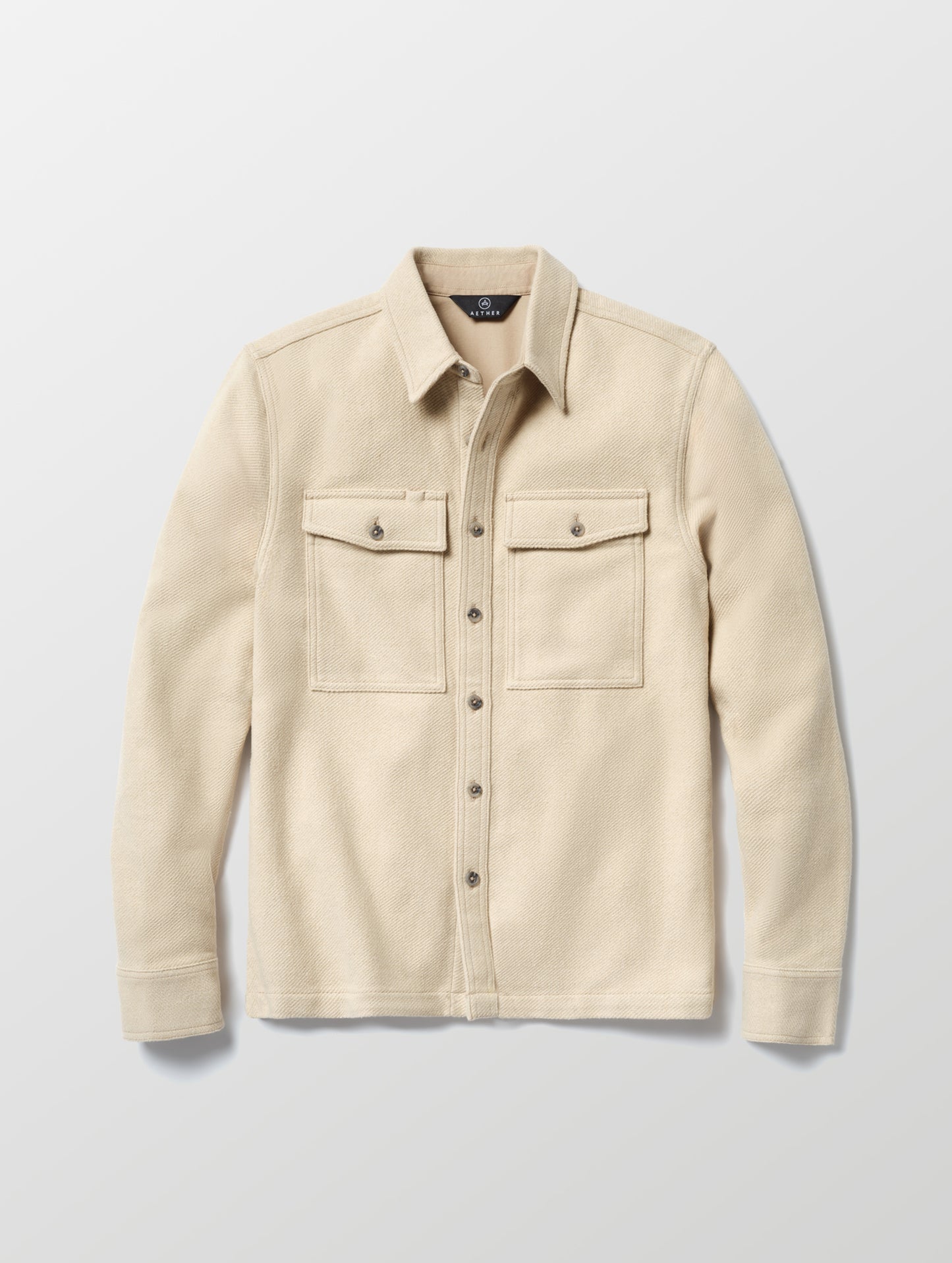 Flat lay of the Pioneer Heavyweight Button-Down in Bone white from AETHER Apparel.