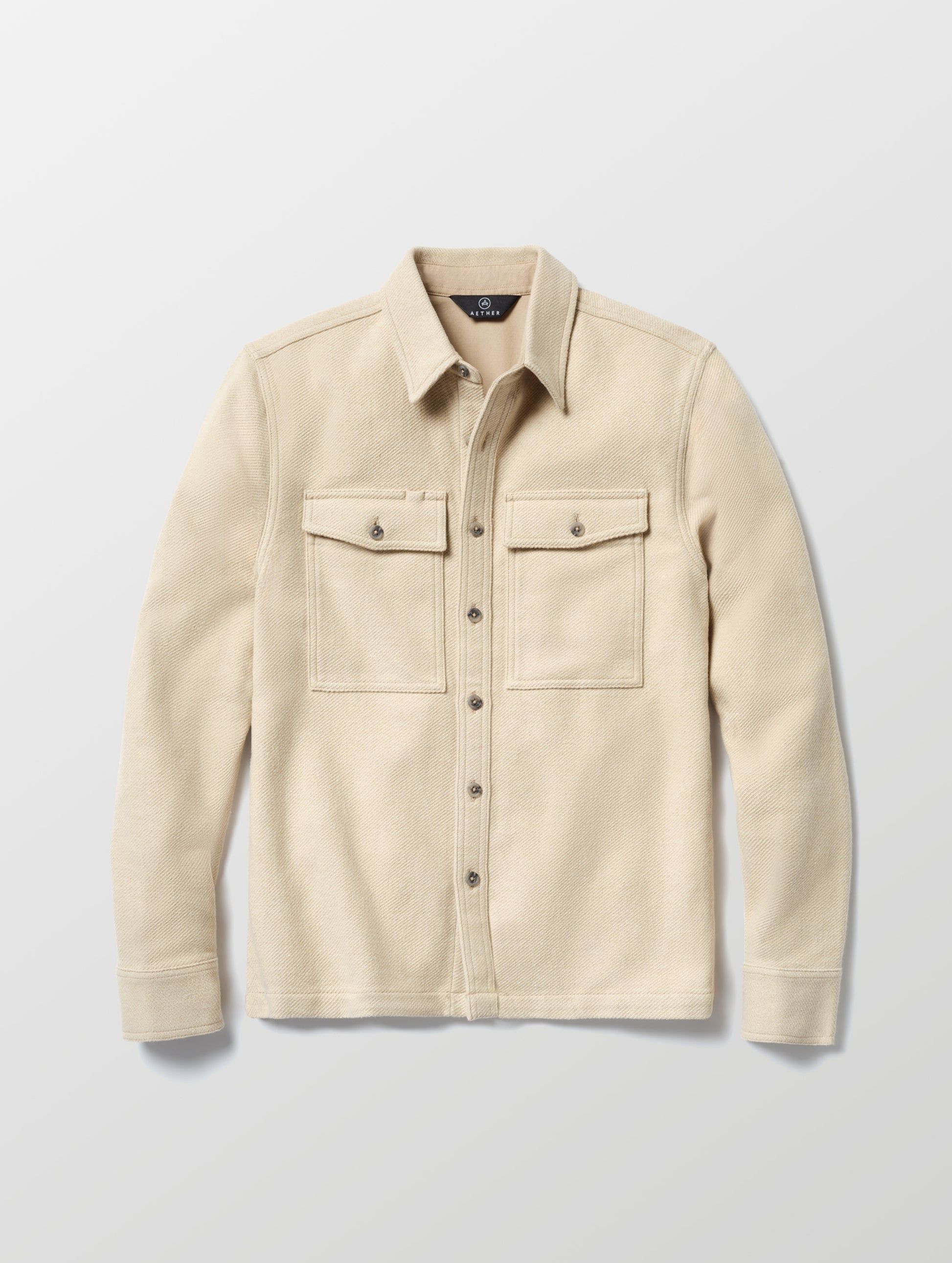 Flat lay of the Pioneer Heavyweight Button-Down in Bone white from AETHER Apparel.
