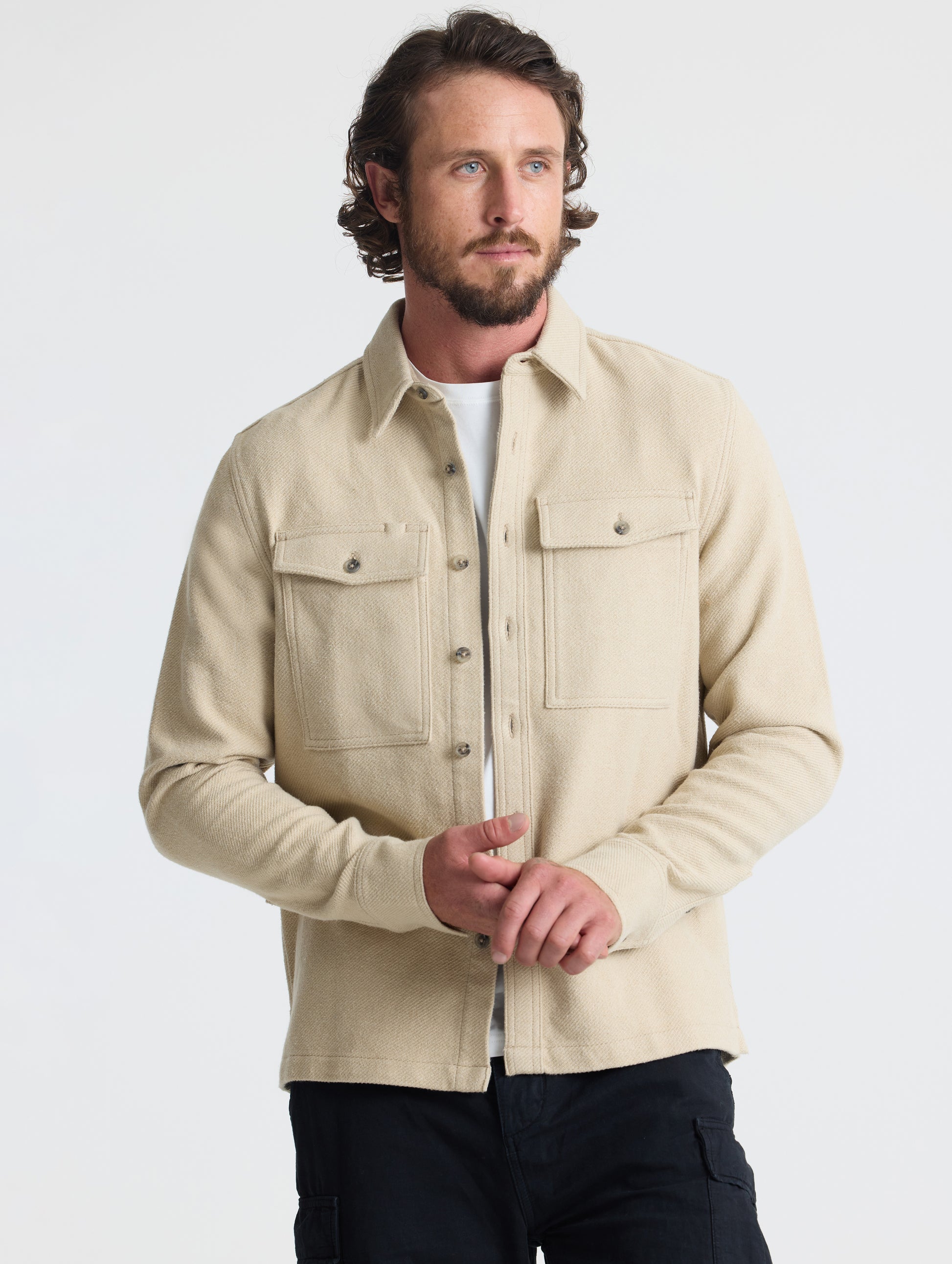Front upper-body view of man wearing Pioneer Heavyweight Button-Down in Bone white from AETHER Apparel.