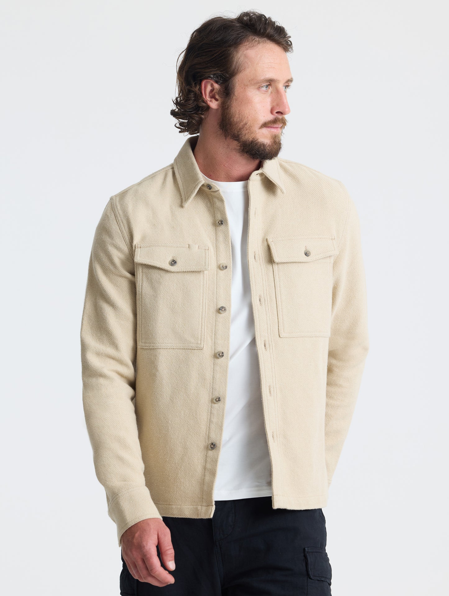 Front, angled upper-body view of man wearing Pioneer Heavyweight Button-Down in Bone white from AETHER Apparel.