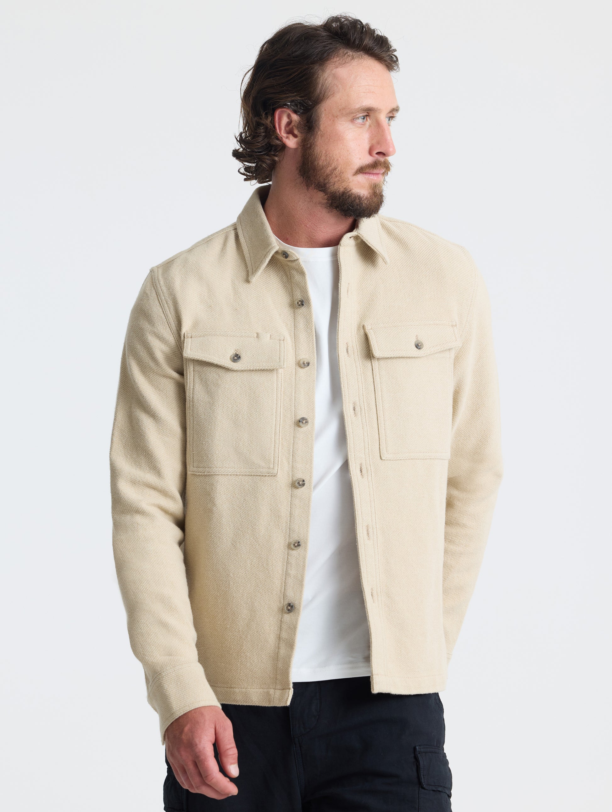 Front, angled upper-body view of man wearing Pioneer Heavyweight Button-Down in Bone white from AETHER Apparel.