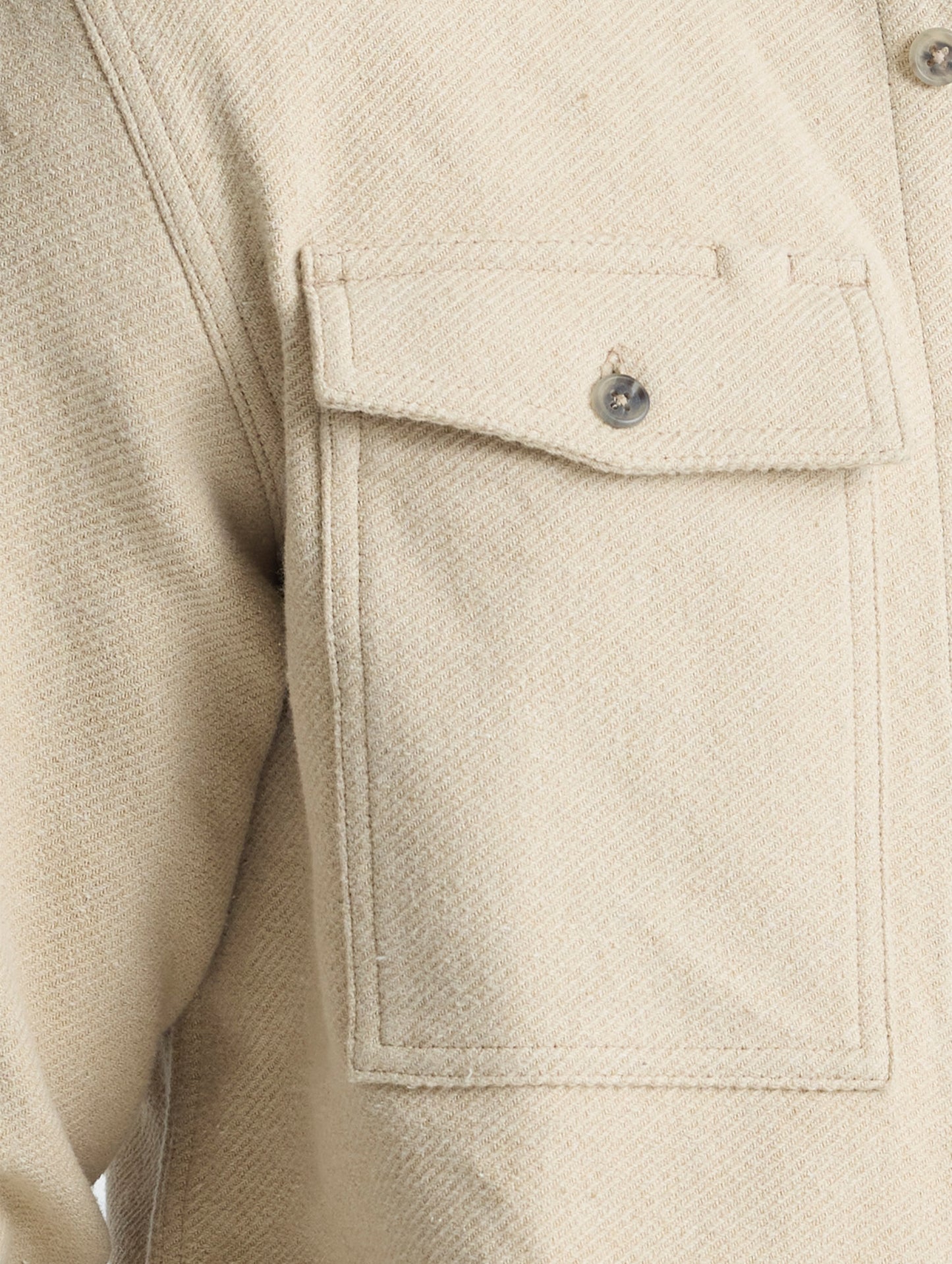 Closeup detailed view of the button-secured chest patch pockets on the Pioneer Heavyweight Button-Down in Bone white from AETHER Apparel.