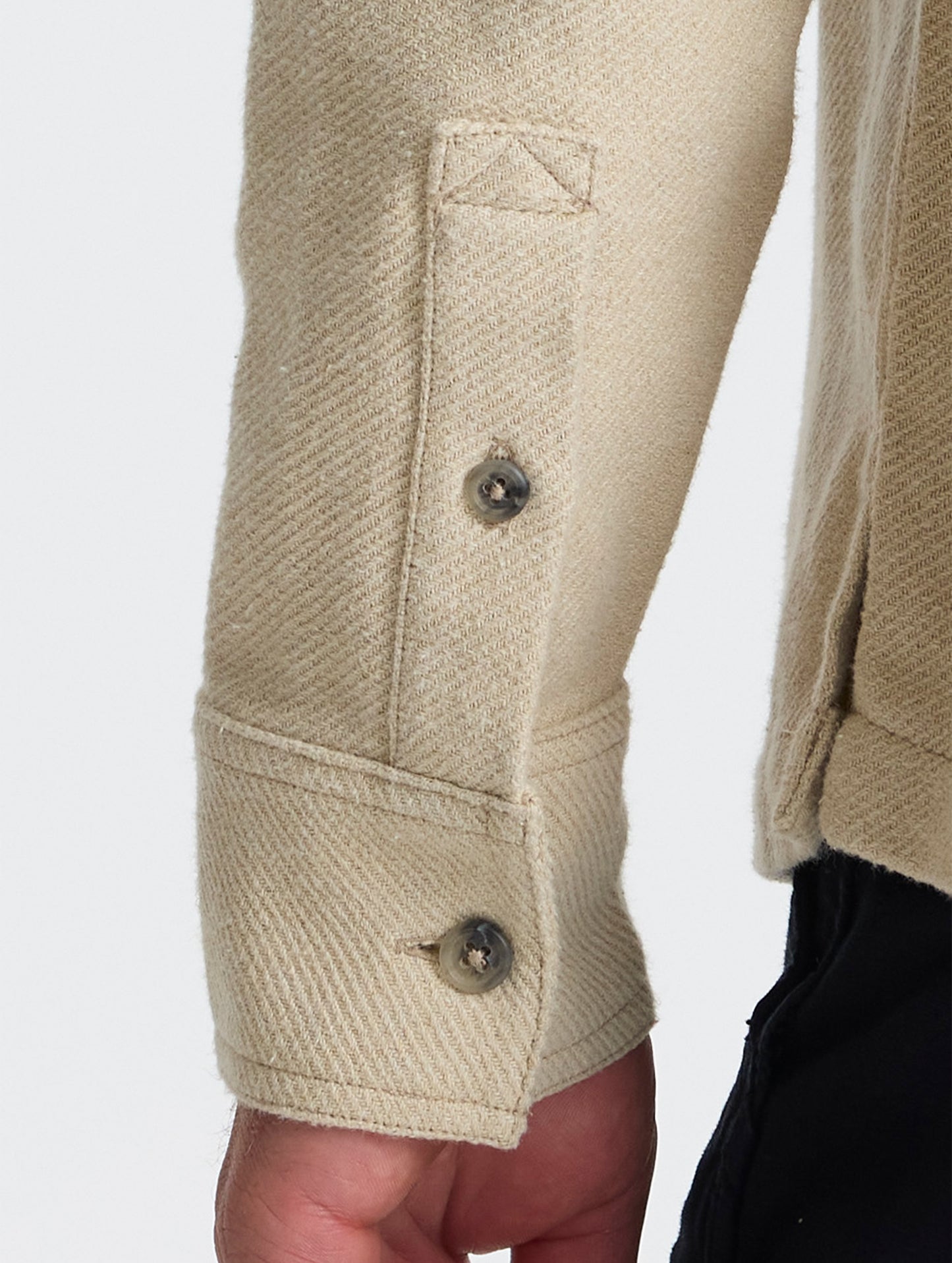 Closeup detailed view of the split cuffs on the Pioneer Heavyweight Button-Down in Bone white from AETHER Apparel.