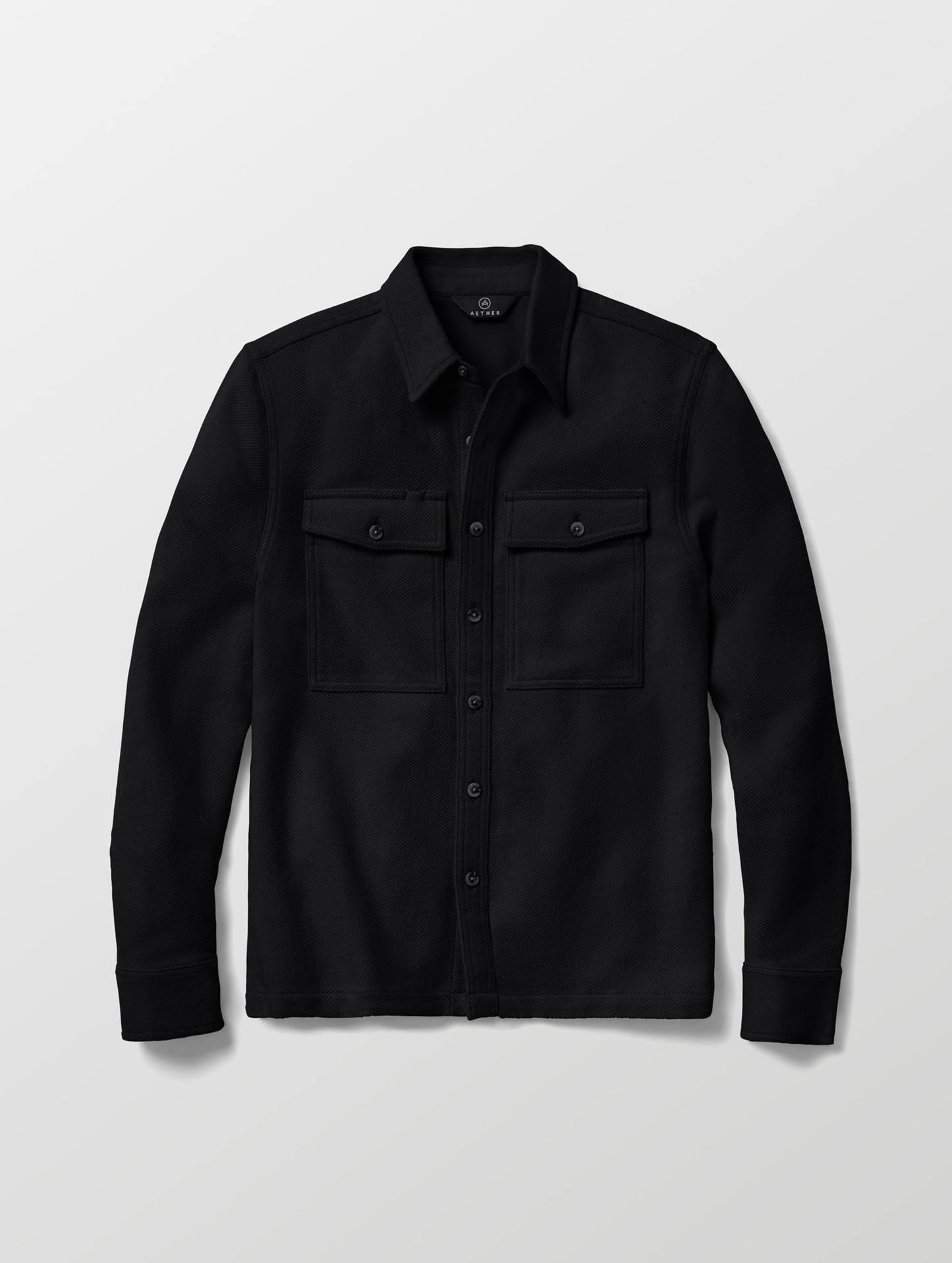 Flat lay of the Pioneer Heavyweight Button-Down in Onyx Black from AETHER Apparel.