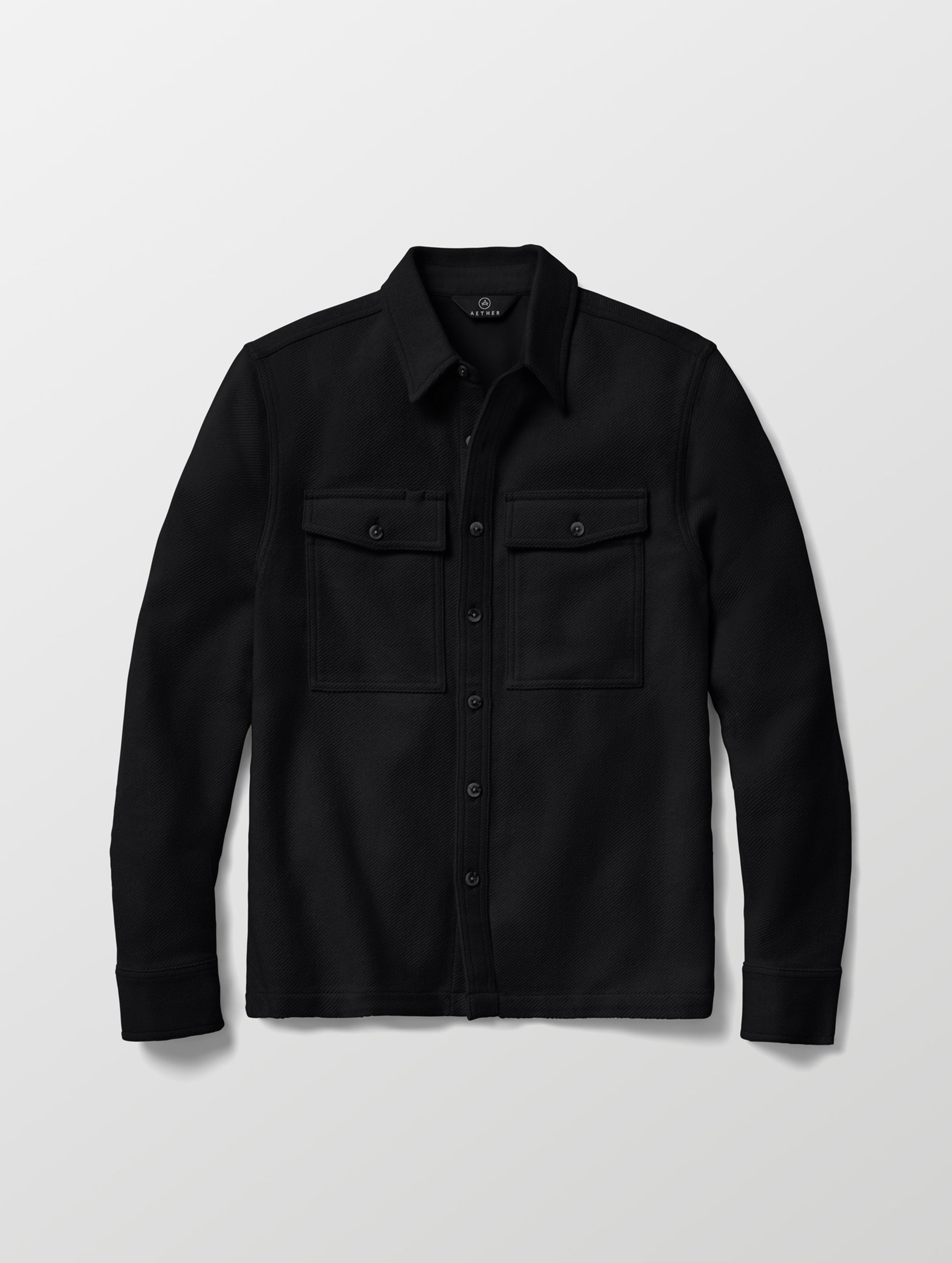 Flat lay of the Pioneer Heavyweight Button-Down in Onyx Black from AETHER Apparel.