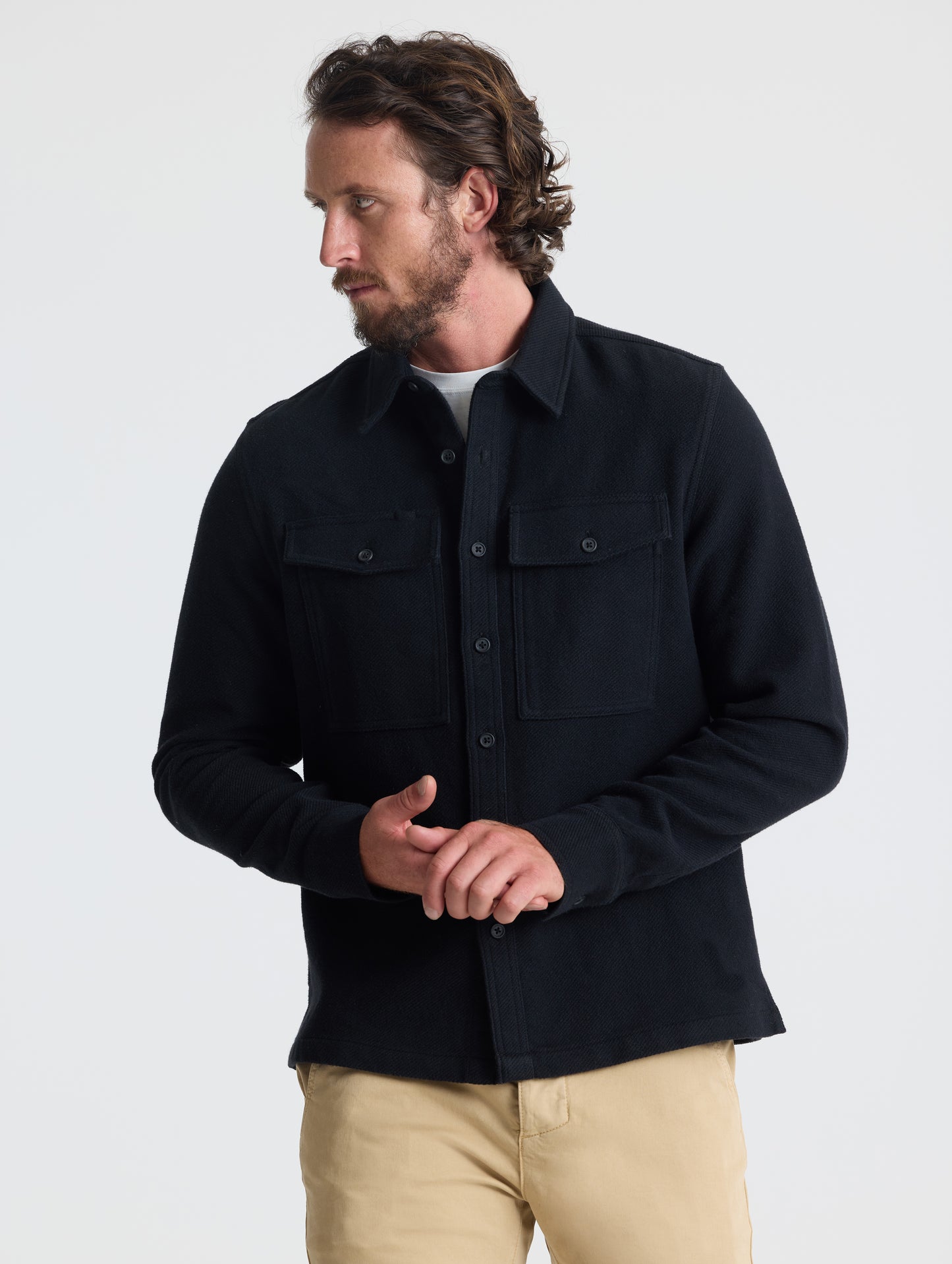 Front upper-body view of man wearing Pioneer Heavyweight Button-Down in Onyx Black from AETHER Apparel.