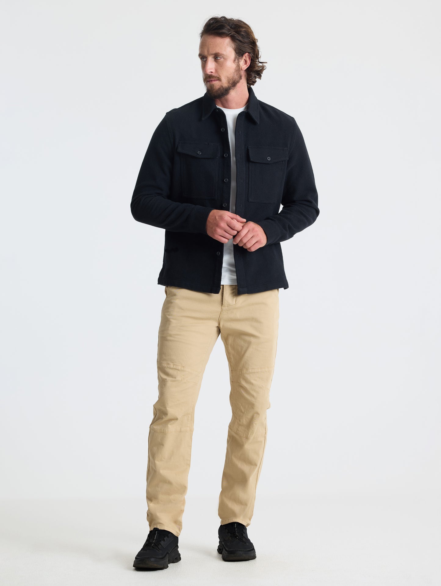 Front full-body view of man wearing Pioneer Heavyweight Button-Down in Onyx Black from AETHER Apparel.