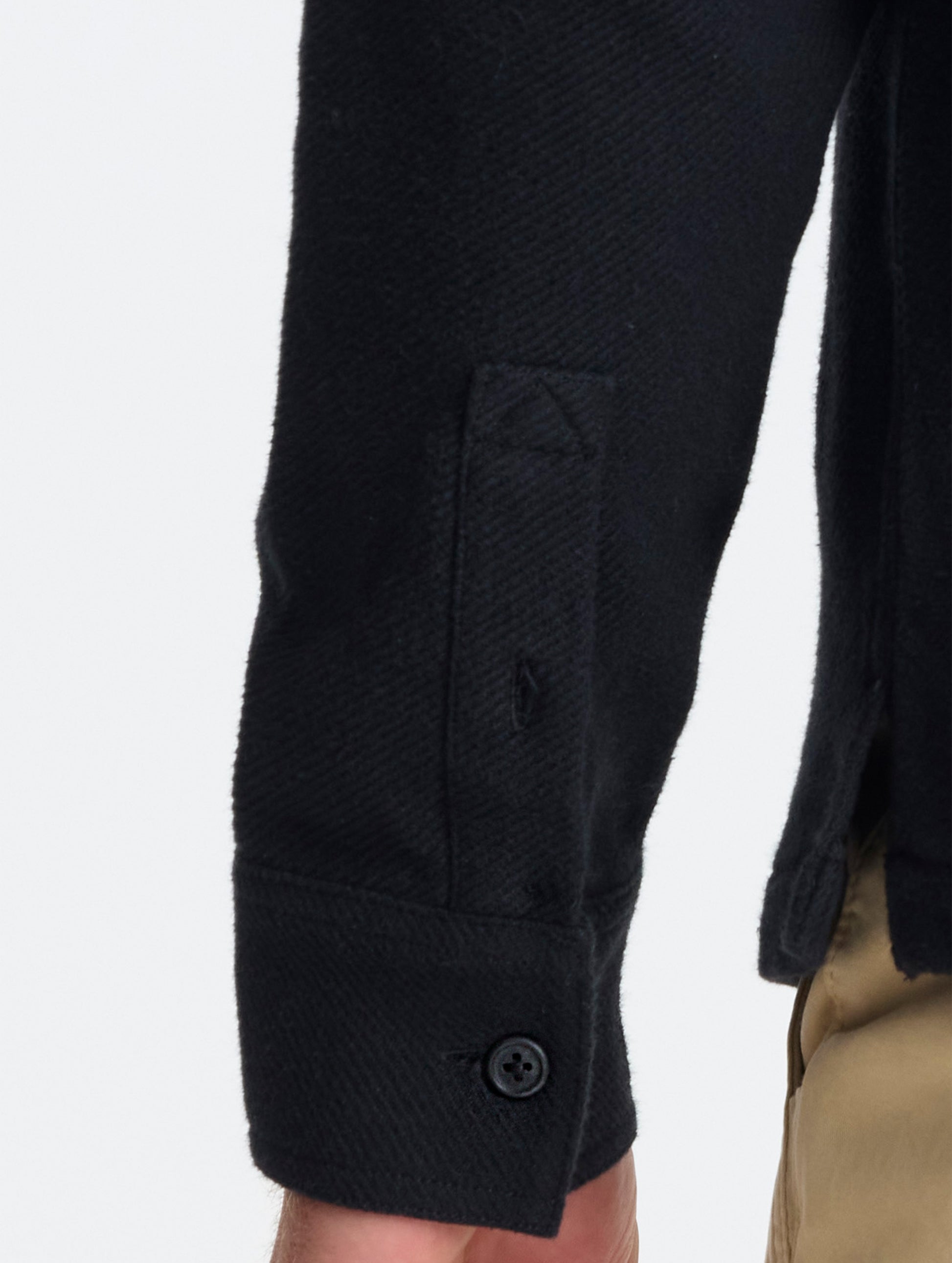 Closeup detailed view of the split cuffs on the Pioneer Heavyweight Button-Down in Onyx Black from AETHER Apparel.