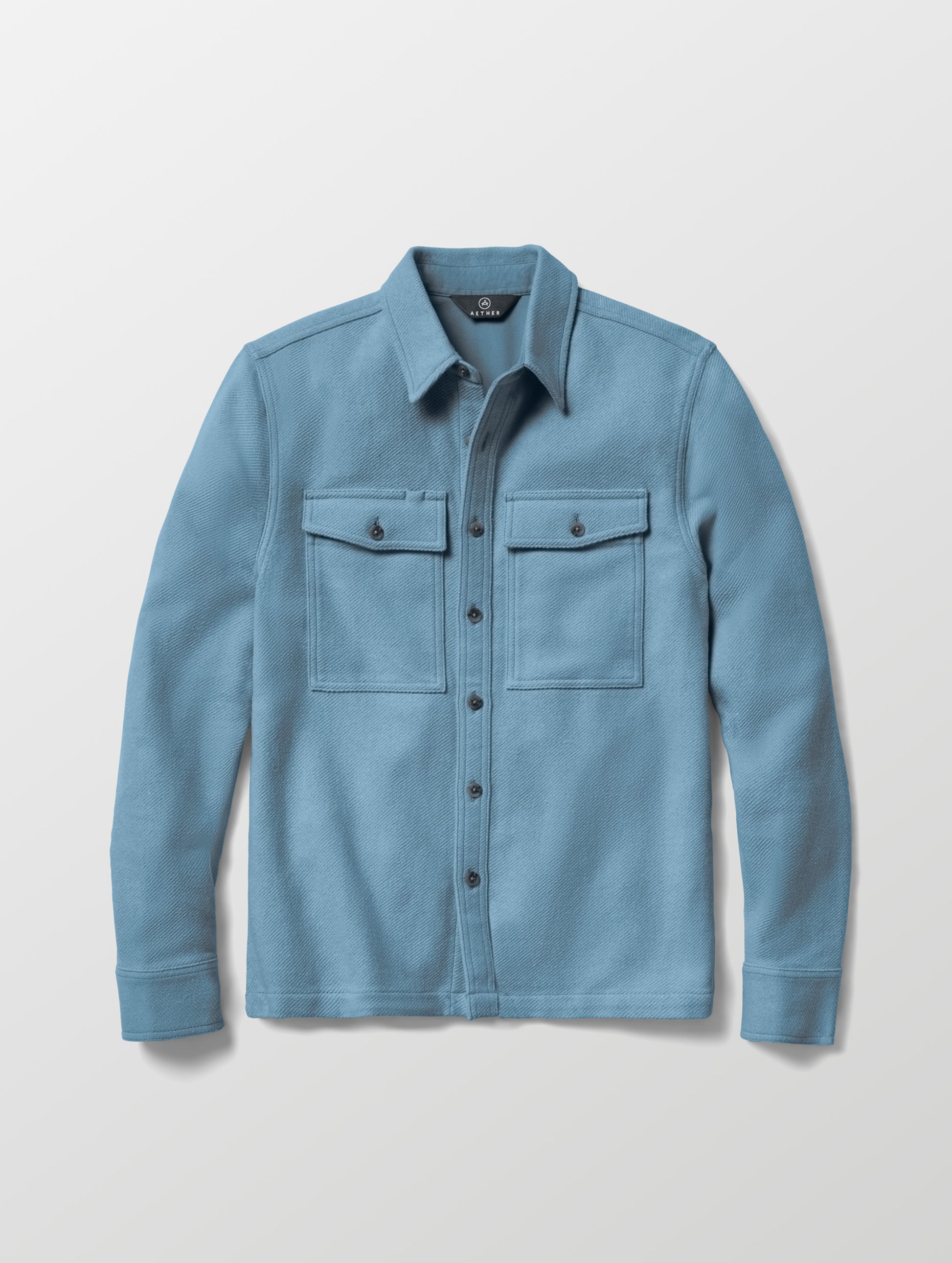 Flat lay of the Pioneer Heavyweight Button-Down in Portal Blue from AETHER Apparel.