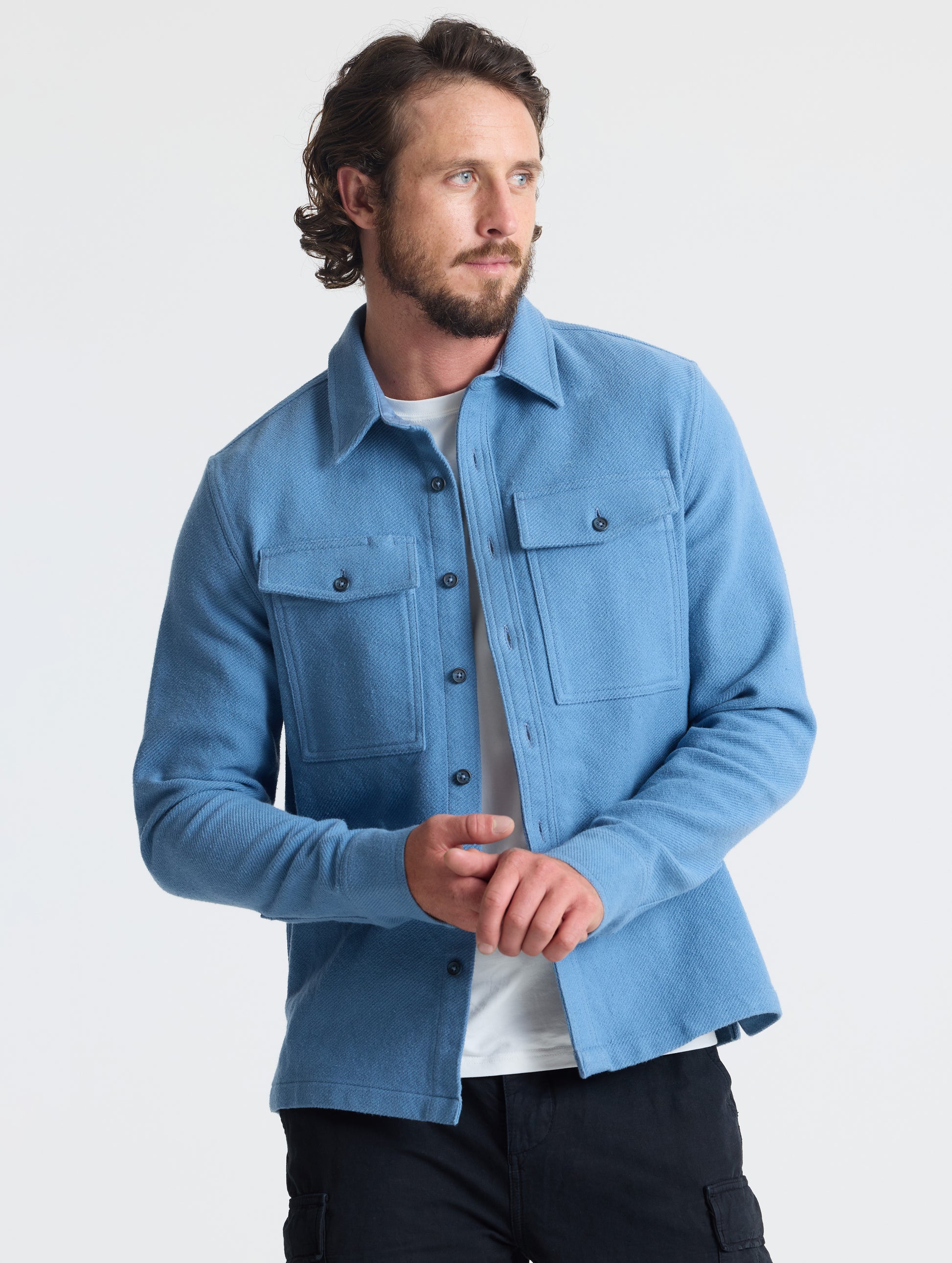 Front upper-body view of man wearing Pioneer Heavyweight Button-Down in Portal Blue from AETHER Apparel.