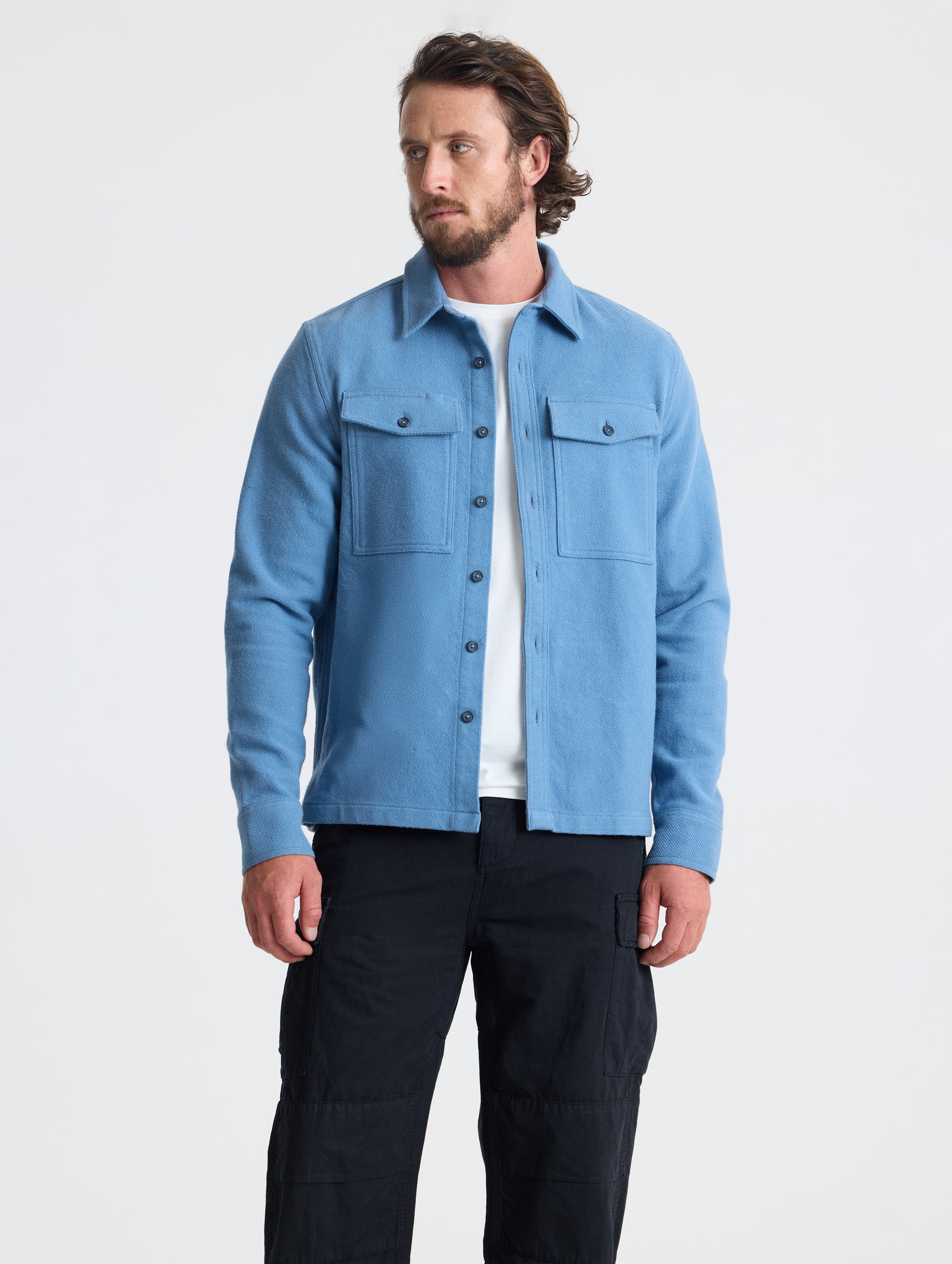 Front full-body view of man wearing Pioneer Heavyweight Button-Down in Portal Blue from AETHER Apparel.