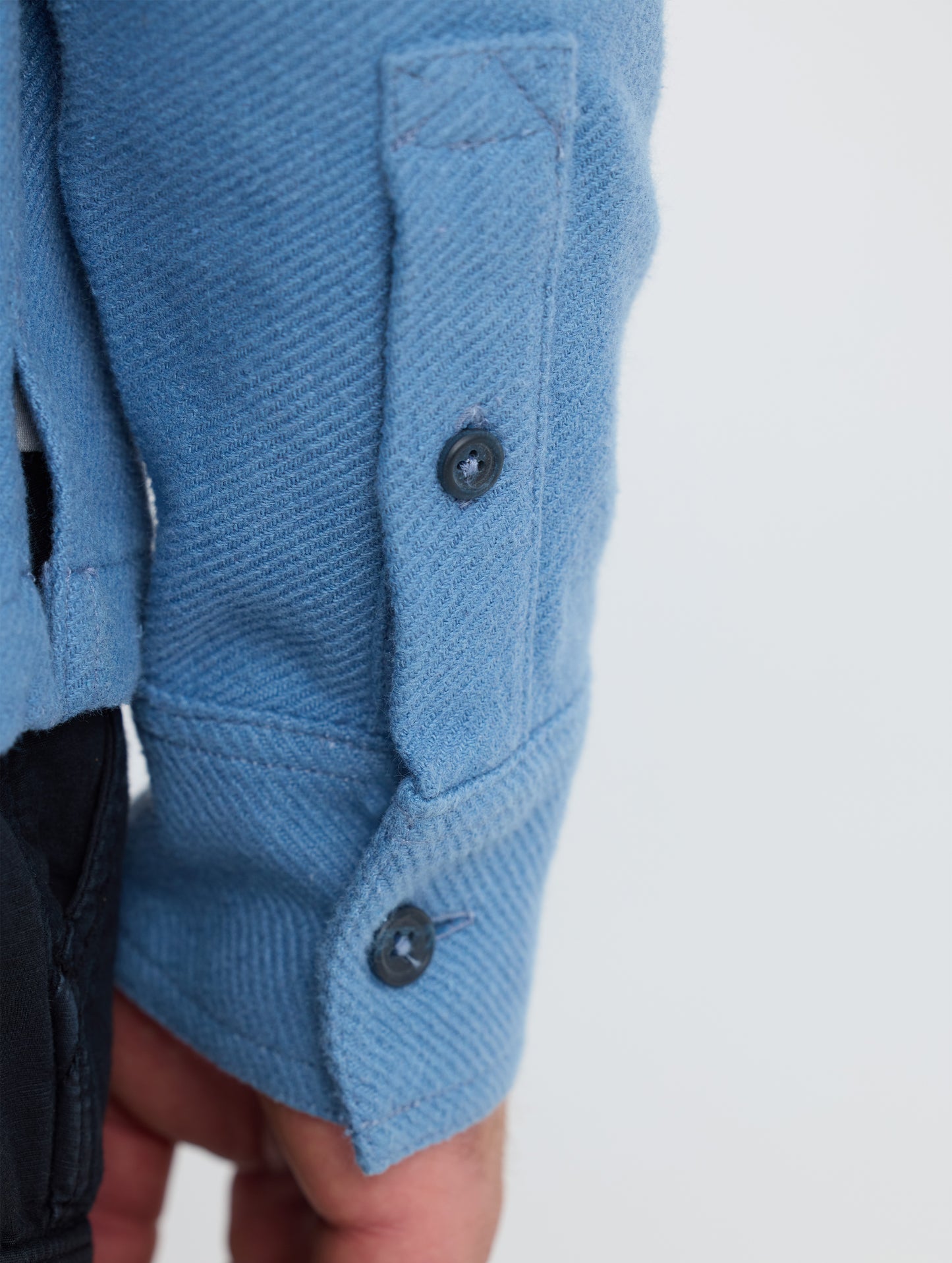 Closeup detailed view of the split cuffs on the Pioneer Heavyweight Button-Down in Portal Blue from AETHER Apparel.