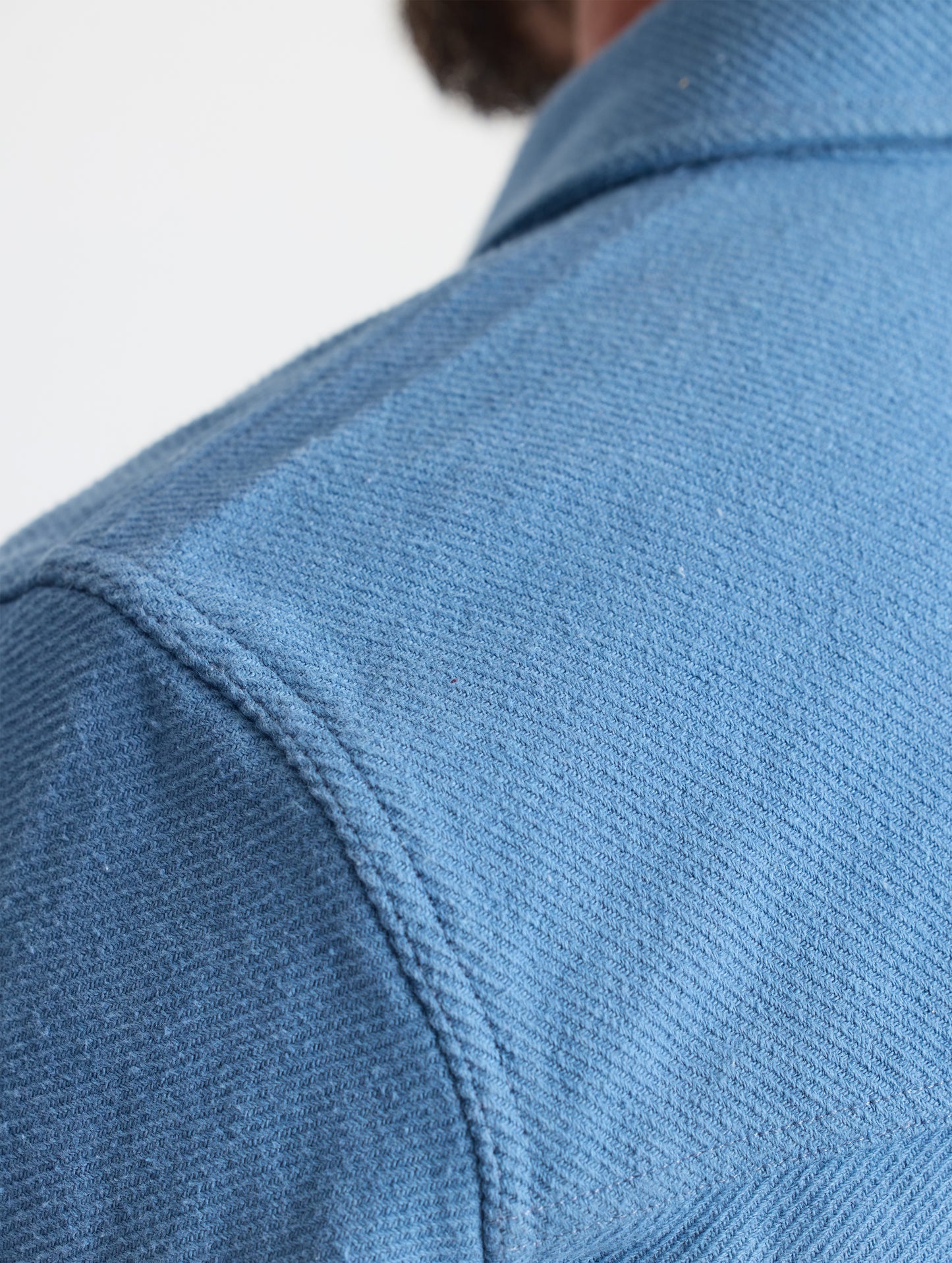 Closeup detailed view of the forward shoulder seams on the Pioneer Heavyweight Button-Down in Portal Blue from AETHER Apparel.