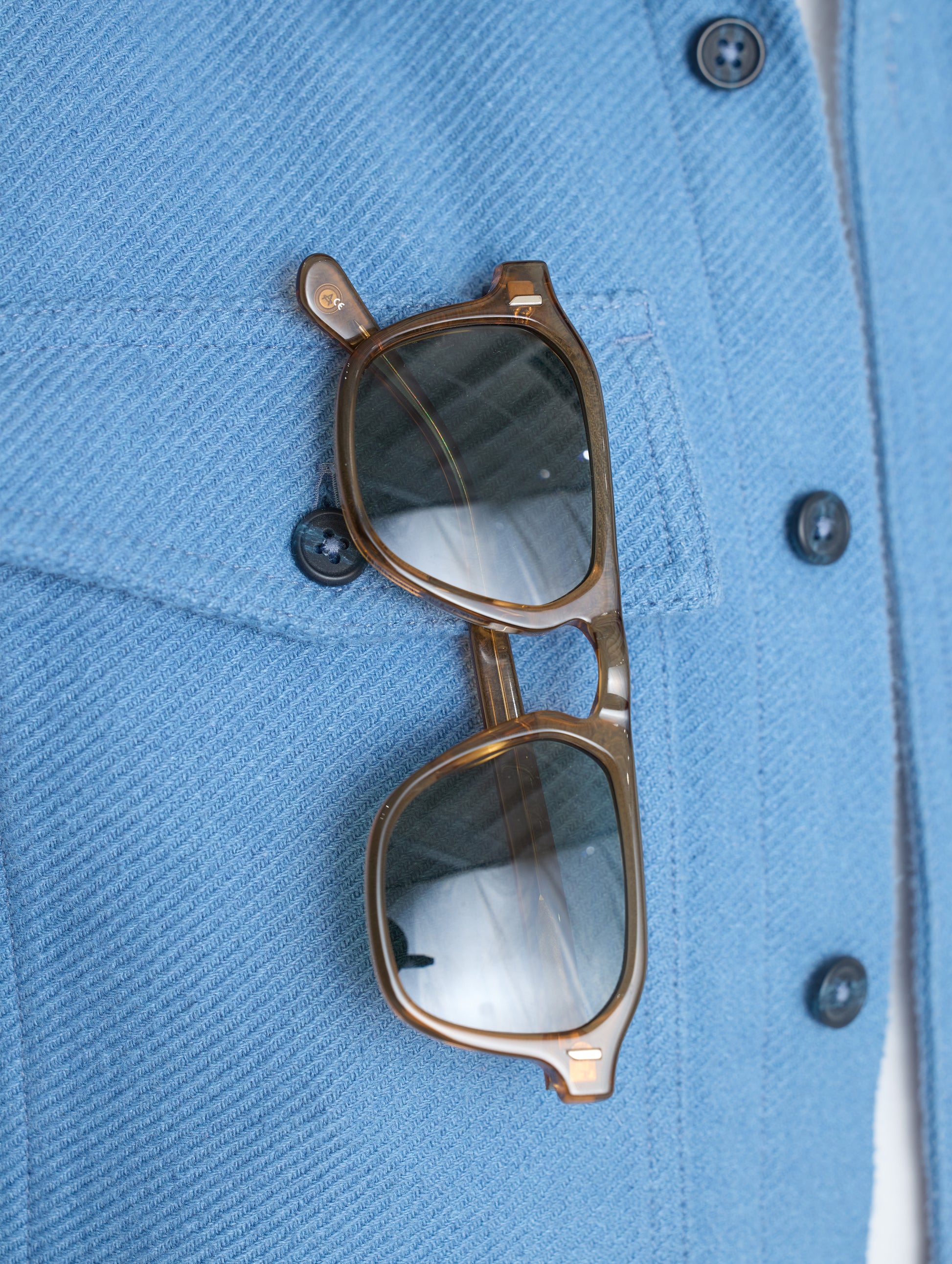Closeup detailed view of the sunglasses slip behind the right patch pocket on the Pioneer Heavyweight Button-Down in Portal Blue from AETHER Apparel.