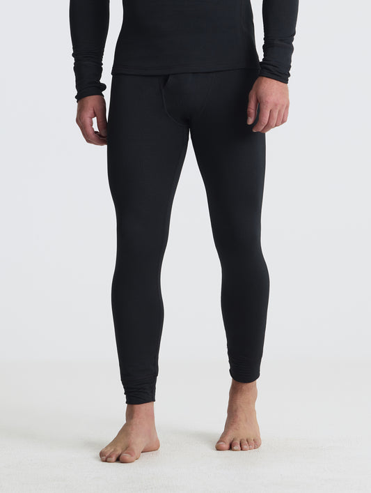Front angled lower-body view of man wearing the Polar Base Layer Pant in Onyx Black from AETHER Apparel.