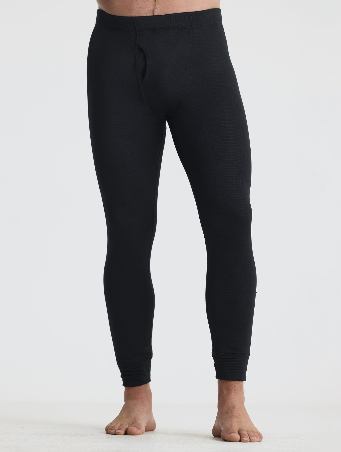 Front lower-body view of man wearing the Polar Base Layer Pant in Onyx Black from AETHER Apparel.