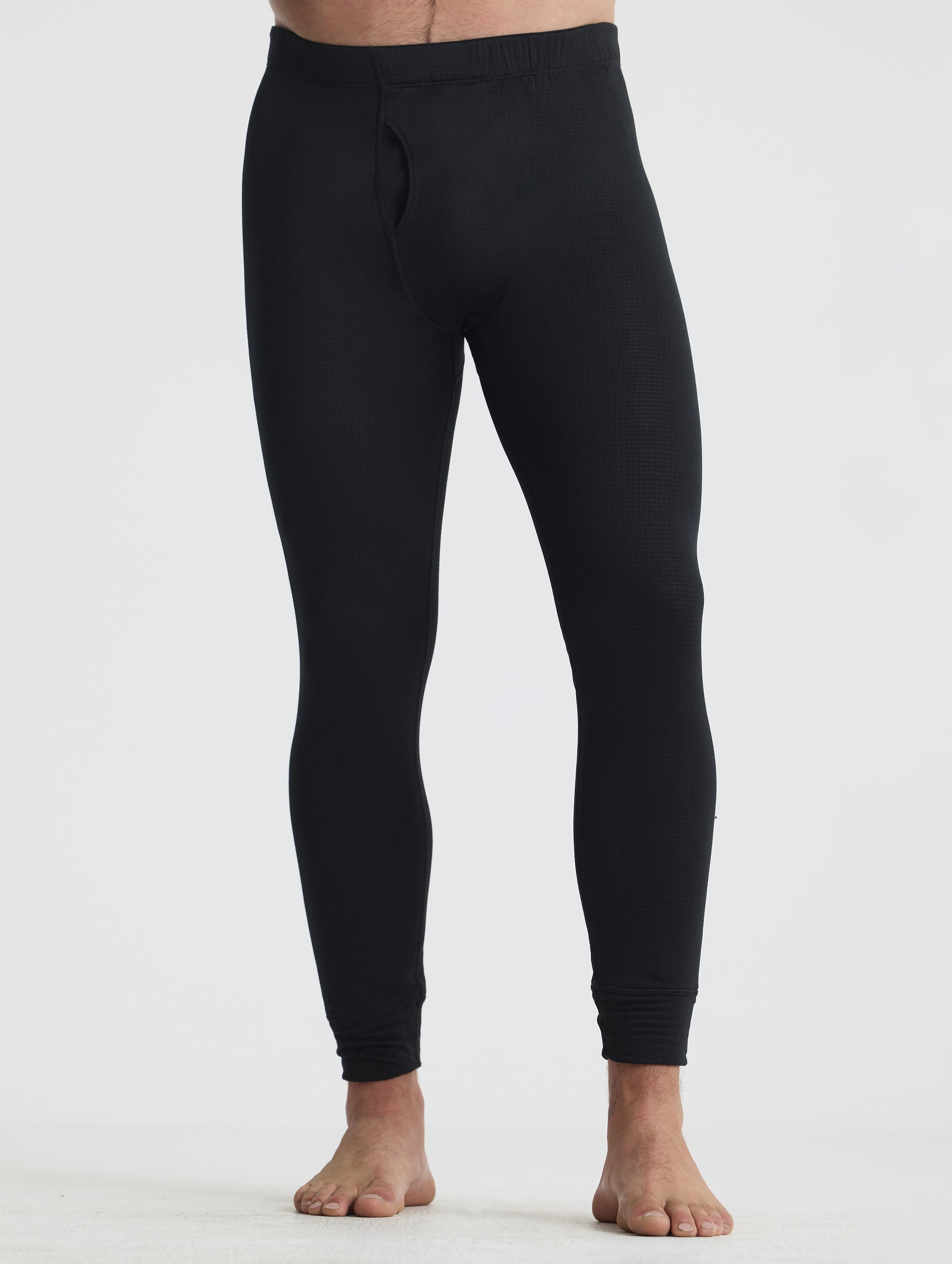 Front lower-body view of man wearing the Polar Base Layer Pant in Onyx Black from AETHER Apparel.