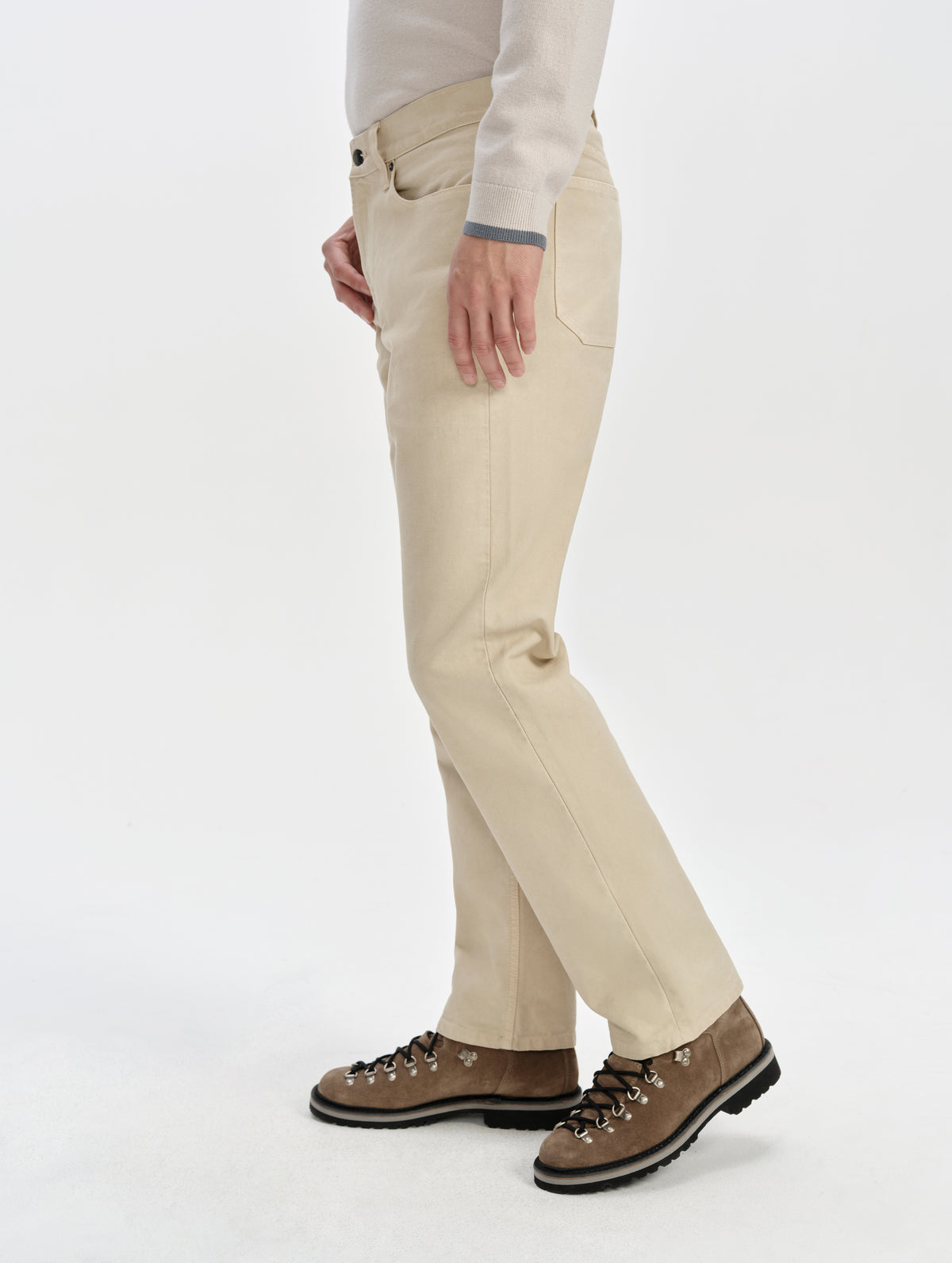 Side profile lower-body view of man wearing the Porter 5-Pocket Pant in Bone from AETHER Apparel.