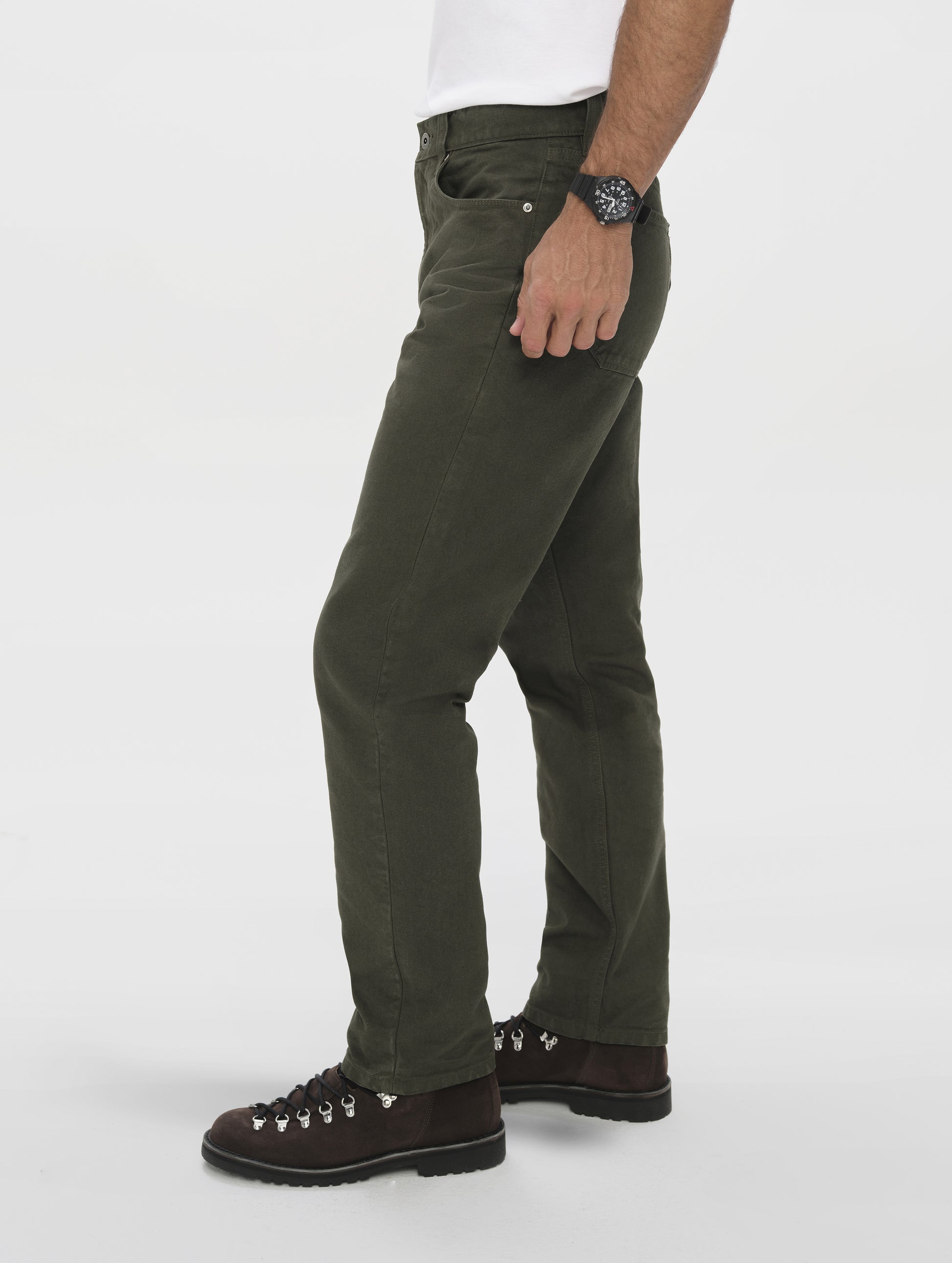 Side profile lower-body view of man wearing the Porter 5-Pocket Pant in Forest Green from AETHER Apparel.