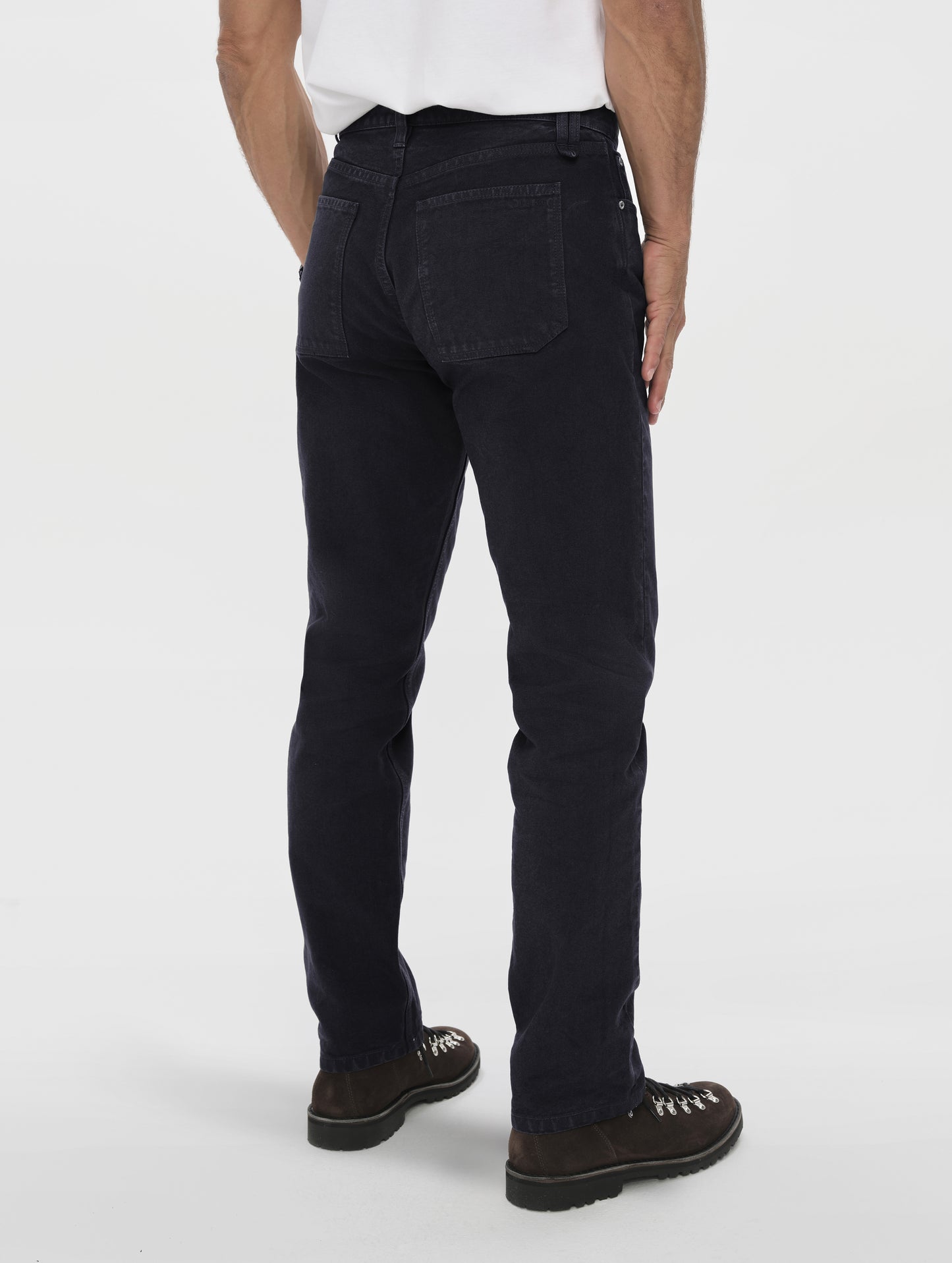 Rear angled lower-body view of man wearing the Porter 5-Pocket Pant in Onyx Black from AETHER Apparel.