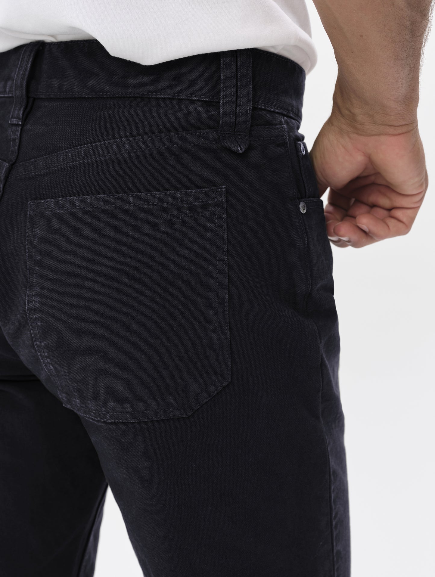 Closeup detailed view of the back pockets and main closure on the Porter 5-Pocket Pant in Onyx Black from AETHER Apparel.